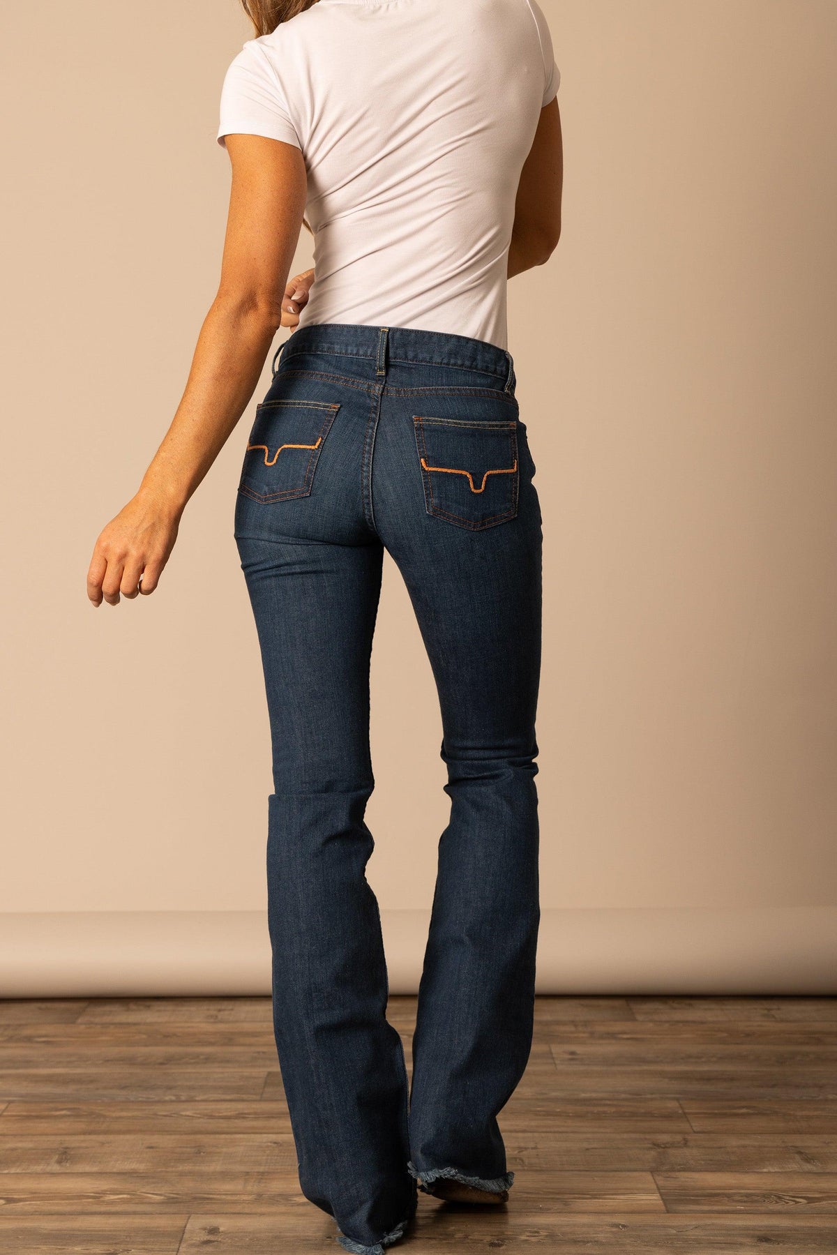 Kimes Ranch Lola, back view, jeans in dark wash with Raw Hem and signature logo stitching on back pockets