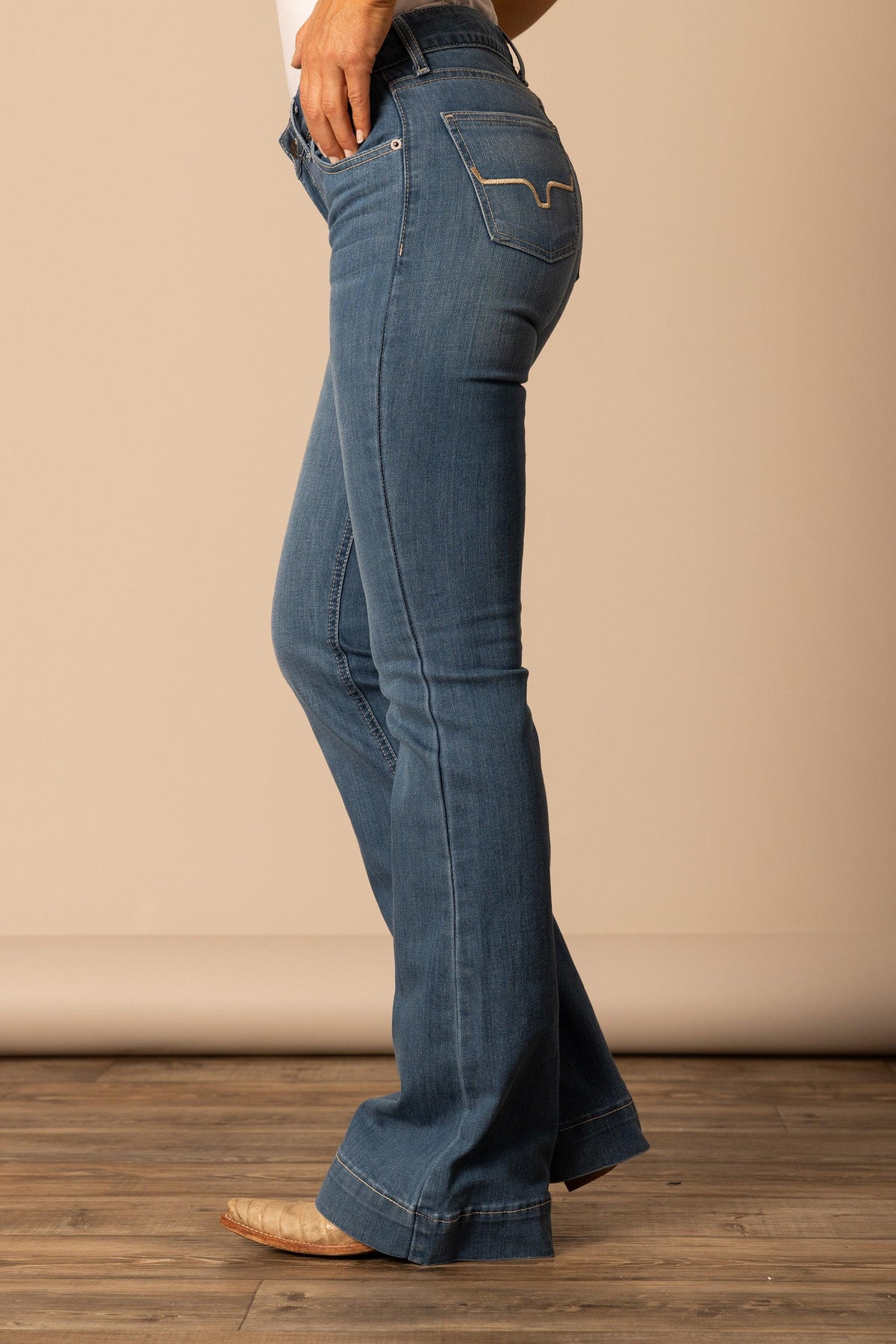 Kimes Ranch Lola jeans in Soho Fade, side view, with the flared leg and back pocket stitching