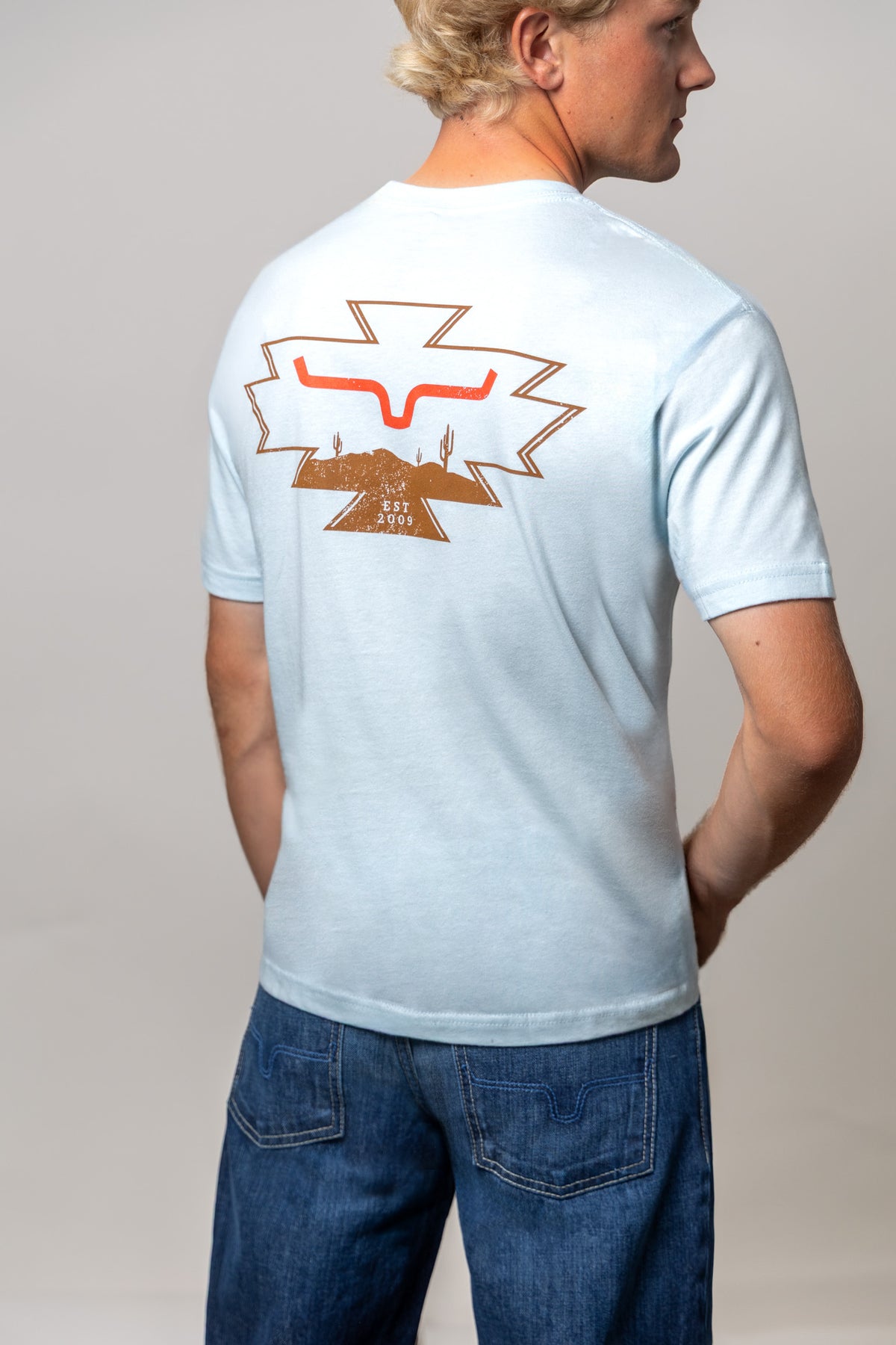 Kimes Ranch Long Live shirt in Light Blue, back view, with a back graphic of the Kimes Ranch logo and cacti