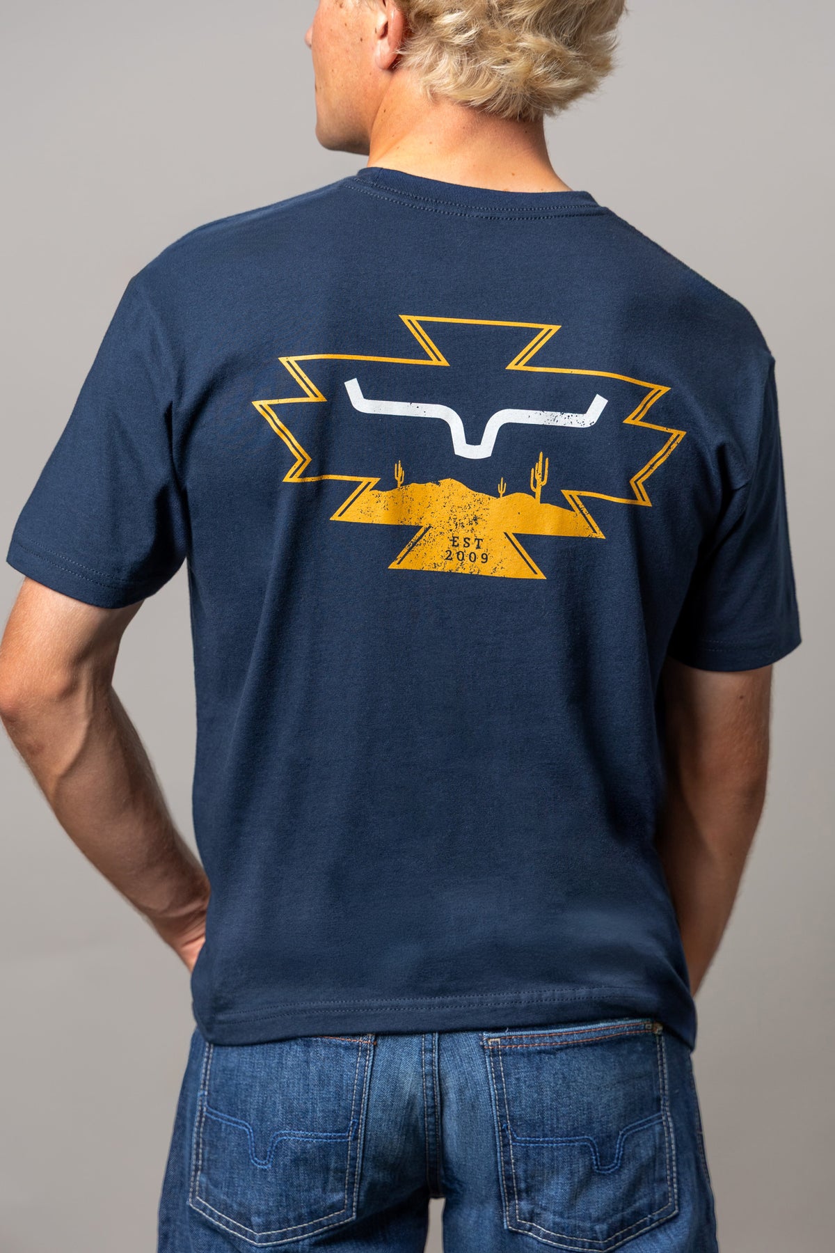 Kimes Ranch Long Live shirt in Midnight Navy, back view, with back graphic of the Kimes Ranch logo over a desert landscape
