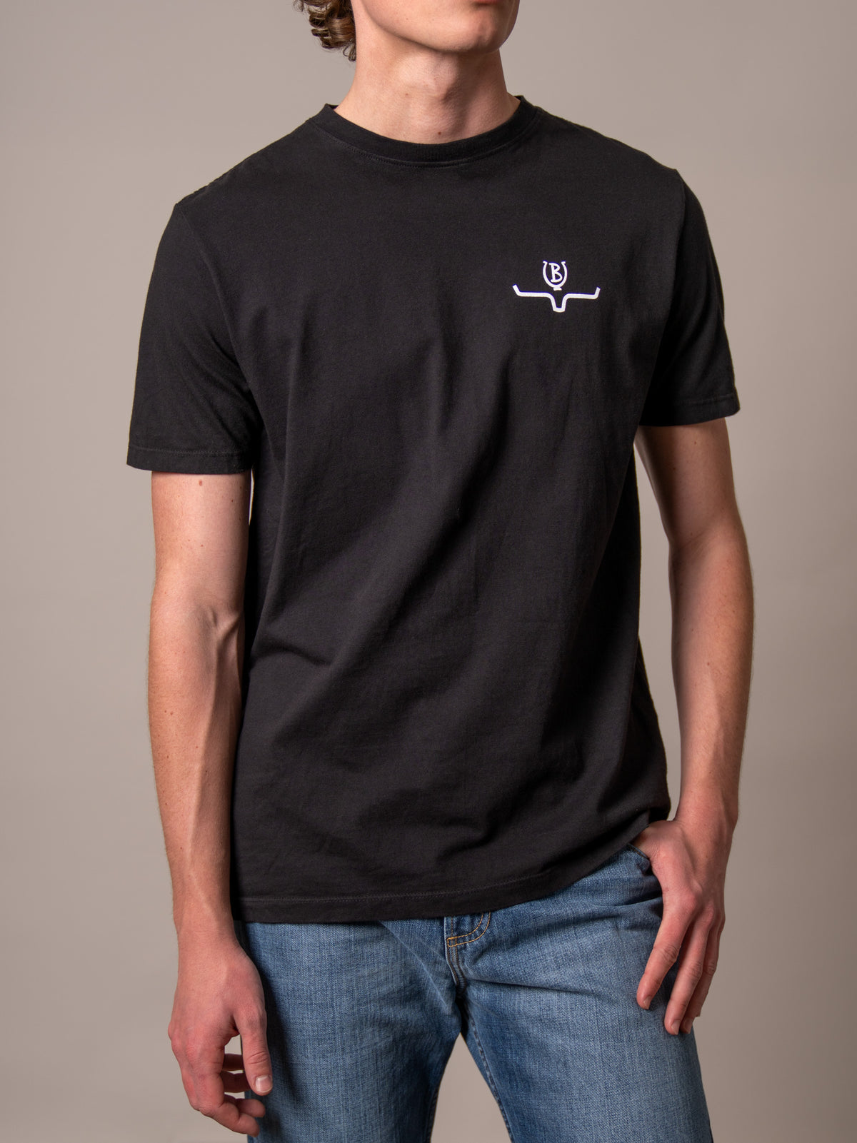 Kimes Ranch Lucky B Bucking Black short sleeve shirt with a white Kimes Ranch logo on the chest