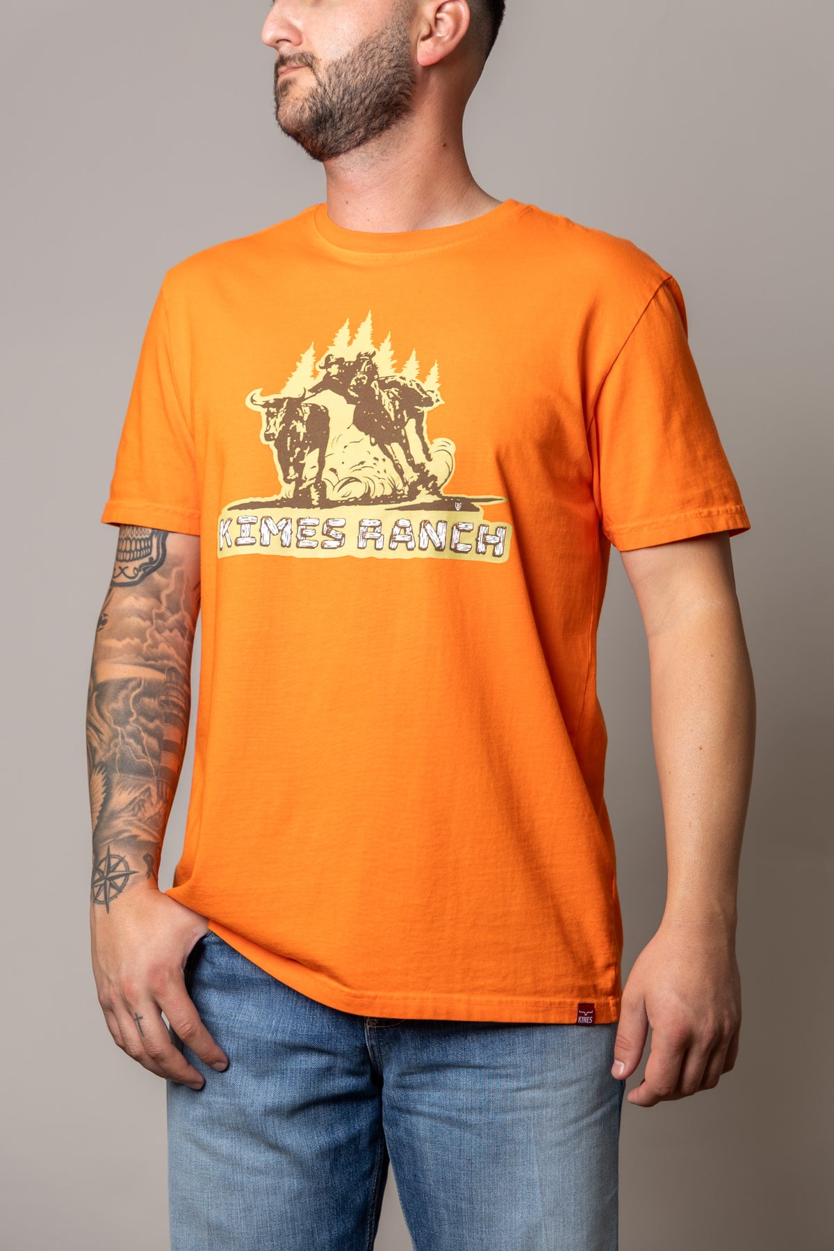 Kimes Ranch Lucky B Bull Dogger shirt in Vintage Orange with a graphic of a cowboy riding a bull with the text KIMES RANCH