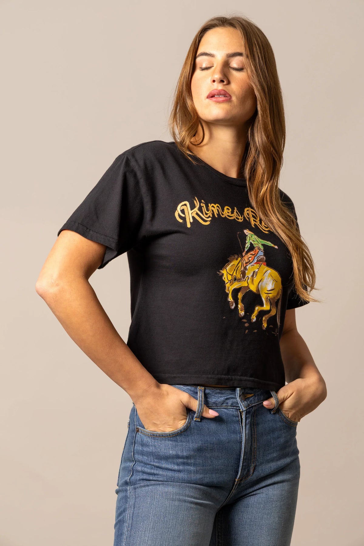 Kimes Ranch Lucky B Rodee-oh! shirt in Black with a graphic of a cowboy on a bucking horse and the brand name in gold script