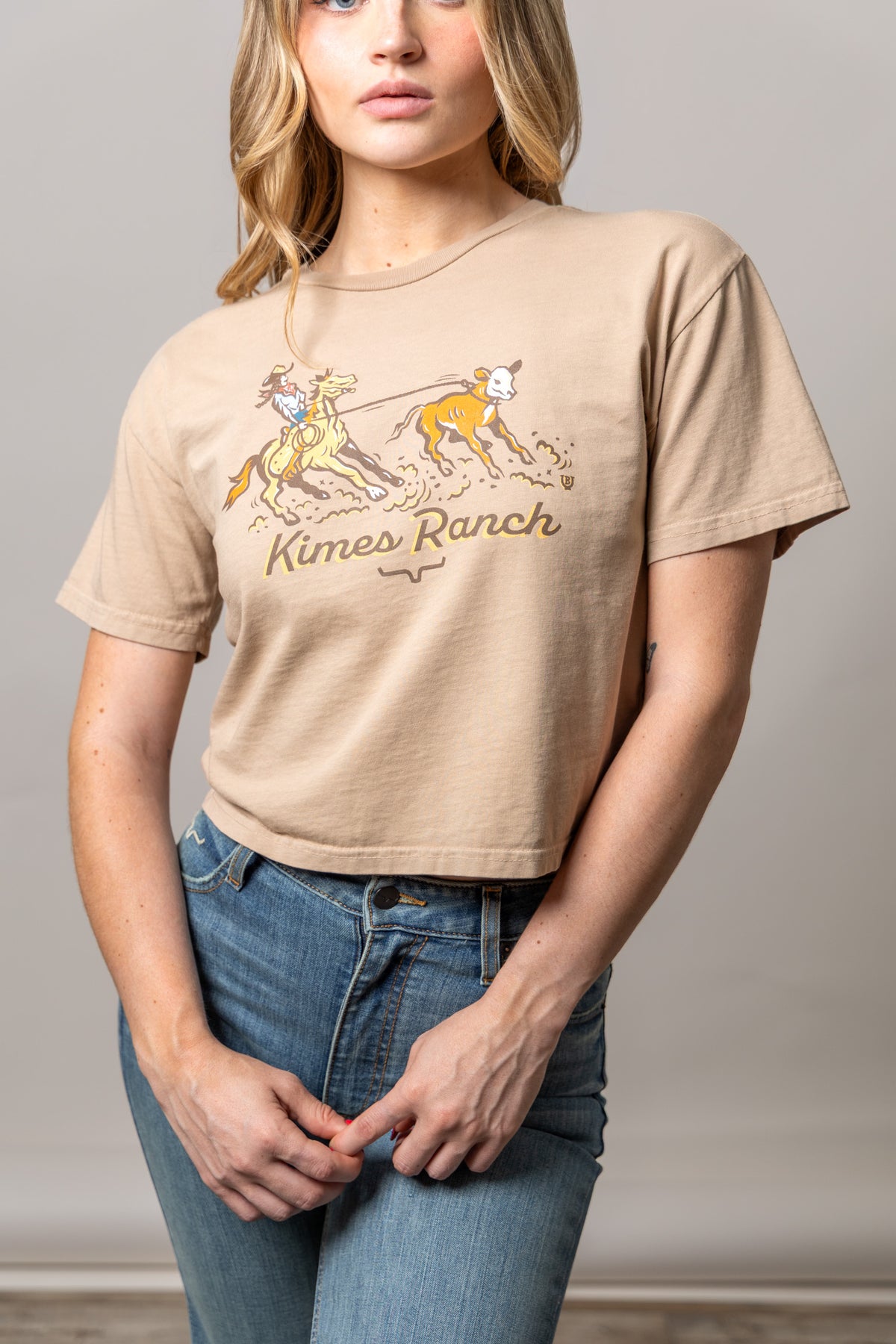 Kimes Ranch Lucky B Roper shirt in Tan with a graphic of a cowboy roping a calf and the Kimes Ranch logo