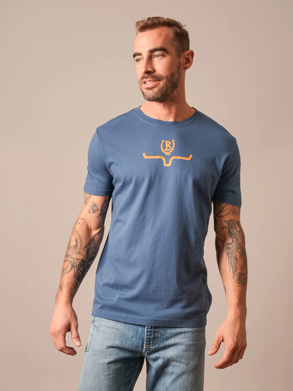 Kimes Ranch Lucky B Saddle shirt in Dark Blue with a short sleeve crew neck and a gold logo on the chest