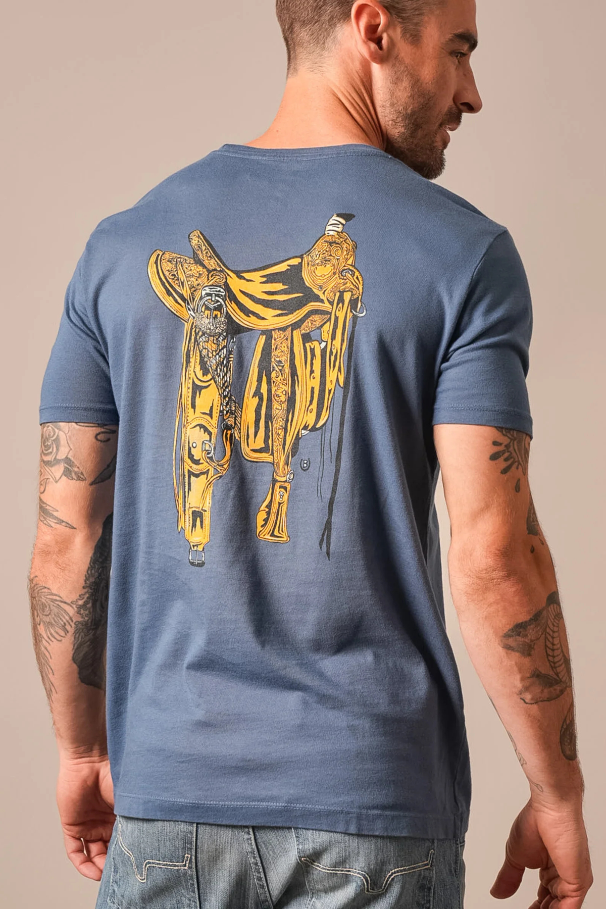 Kimes Ranch Lucky B Saddle shirt in Dark Blue, back view, with a large yellow western saddle graphic on the back
