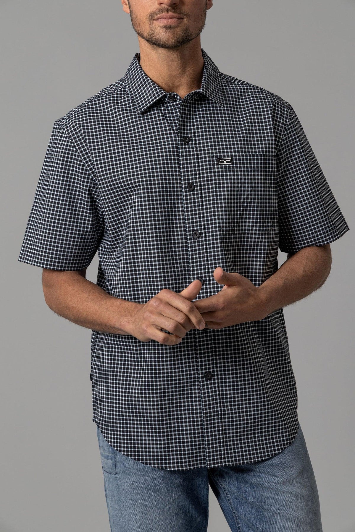 Kimes Ranch MC Cooper short sleeve dress shirt in Black with a white check pattern and a chest pocket