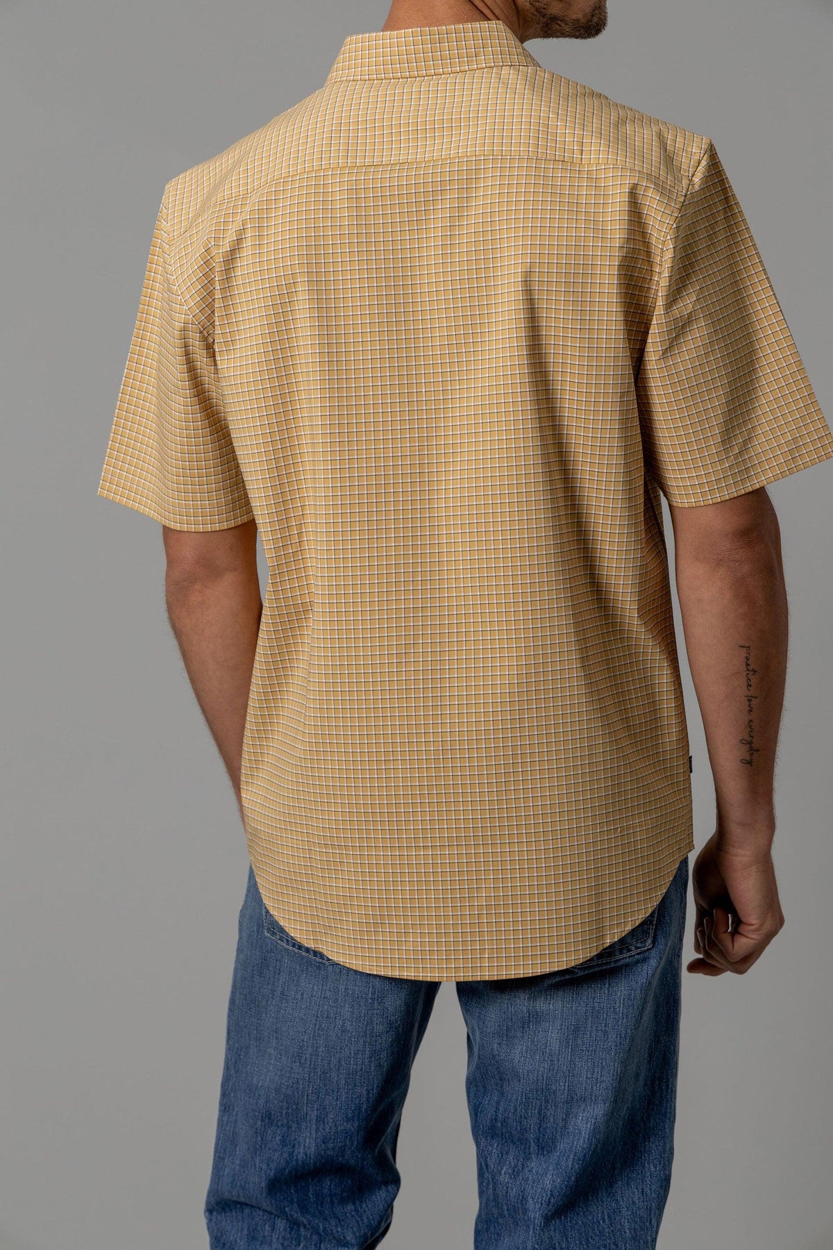 Kimes Ranch MC Cooper dress shirt in Gold, back view, with a short sleeve check pattern and a back yoke