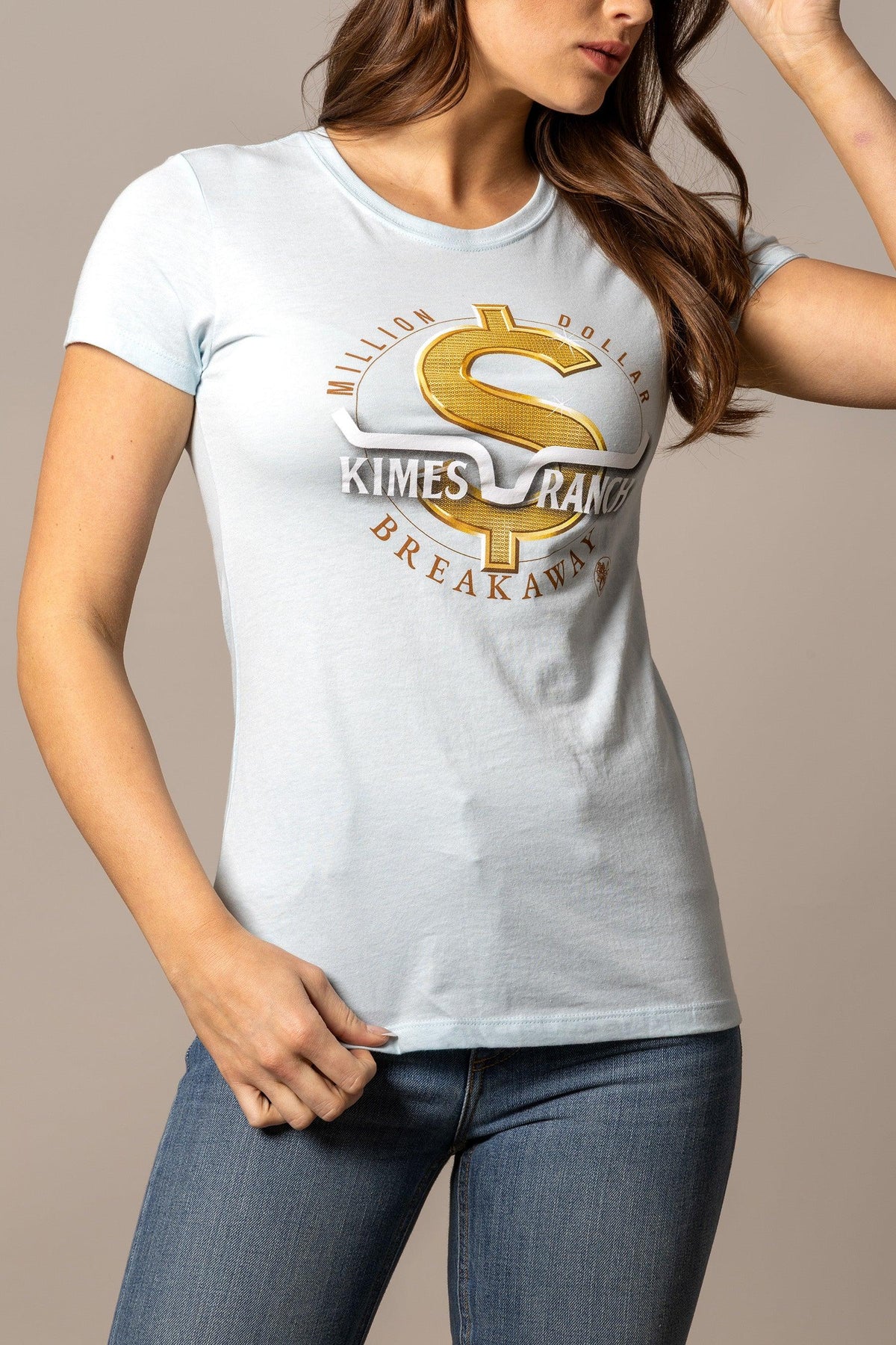 Kimes Ranch Women's MDB Tee in Ice Blue with a gold dollar sign graphic and text reading Million Dollar Breakaway