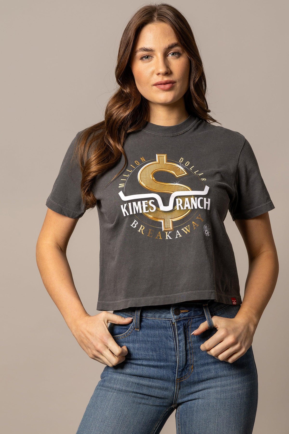 Kimes Ranch MDB Women's Crop Tee in charcoal with a gold dollar sign graphic and Million Dollar Breakaway text