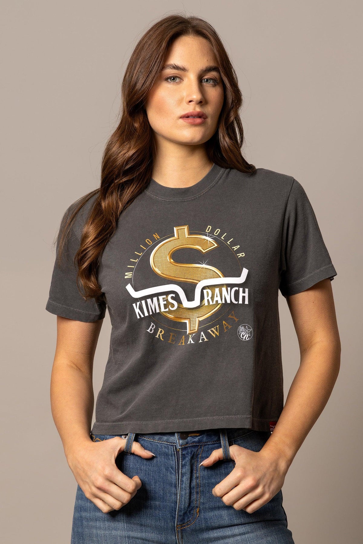 Kimes Ranch MDB Women's Crop Tee in charcoal with a gold dollar sign graphic and 'Million Dollar Breakaway' text