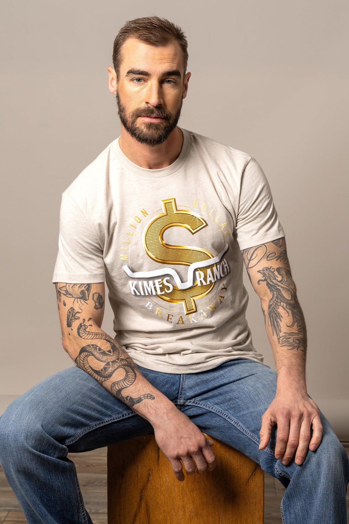 Kimes Ranch Men's MDB Tee in tan with a gold dollar sign graphic with Million Dollar Breakaway text
