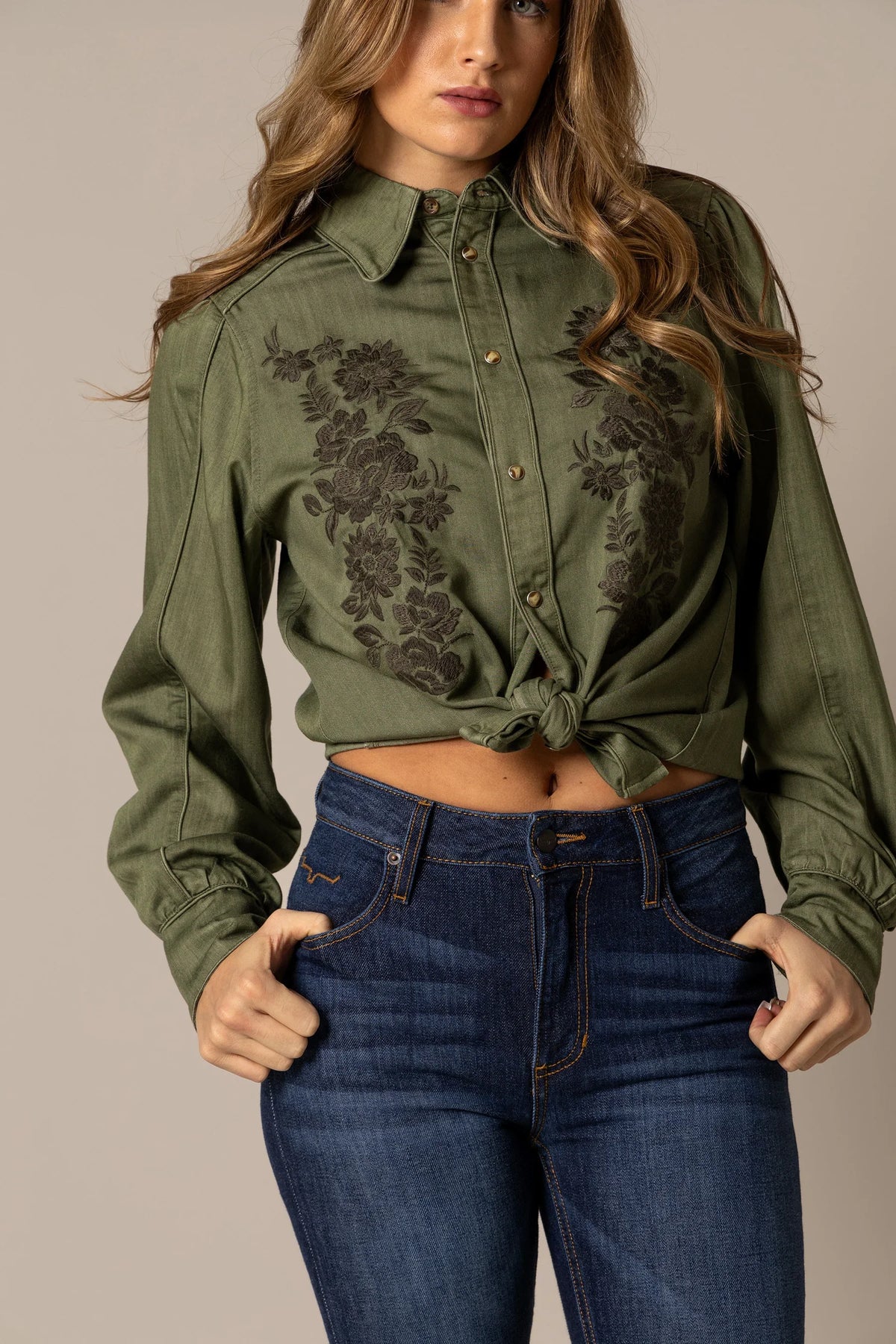 Kimes Ranch Mae top in Olive with long sleeves, button front, and floral embroidery on the chest