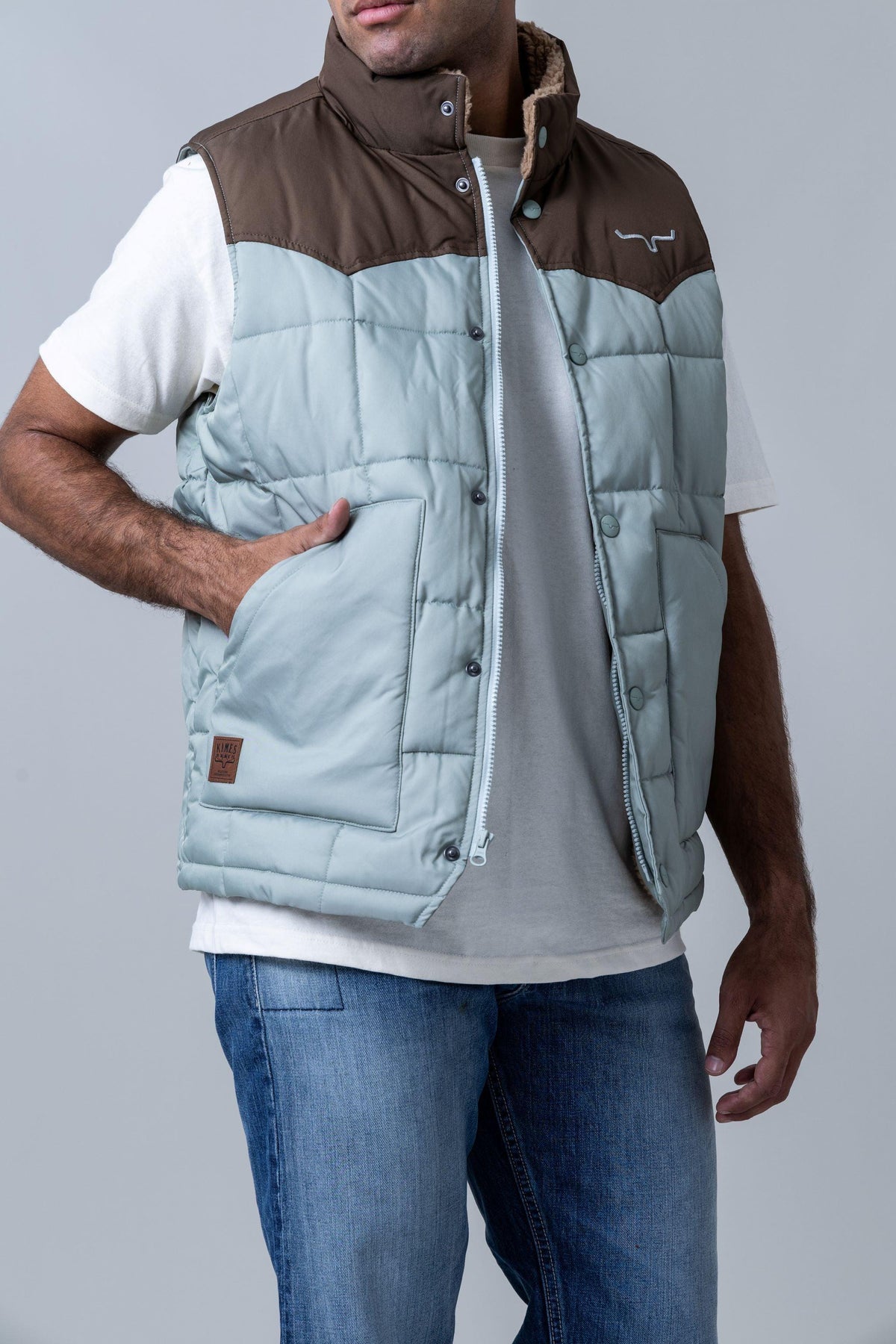 Kimes Ranch Muir Trail Vest in Sage with brown yoke and Kimes Ranch logo