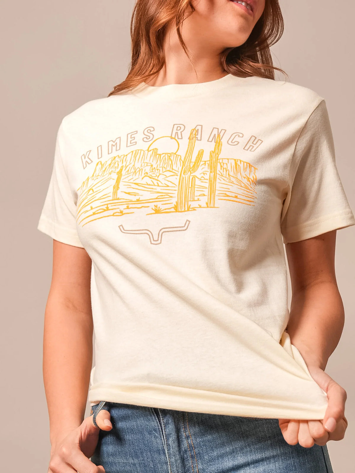 Kimes Ranch Mountain Badge shirt in Cream with a desert landscape graphic and the Kimes Ranch logo