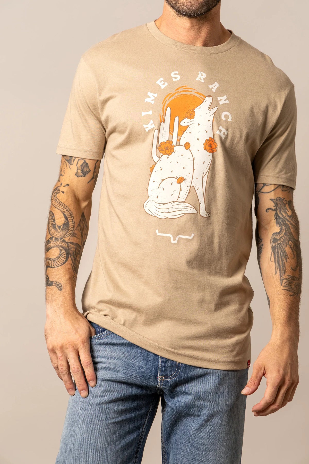 Kimes Ranch Night Call Tan t-shirt with a howling wolf and cactus graphic with the Kimes Ranch logo