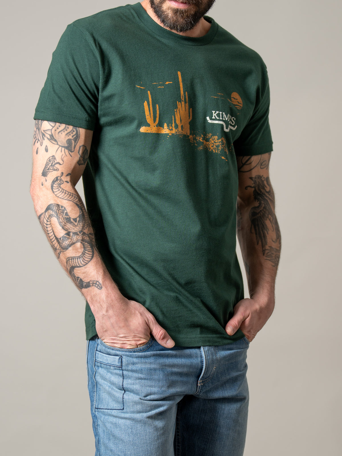 Kimes Ranch Night Fall shirt in Forest Green with a desert sunset graphic and Kimes Ranch logo