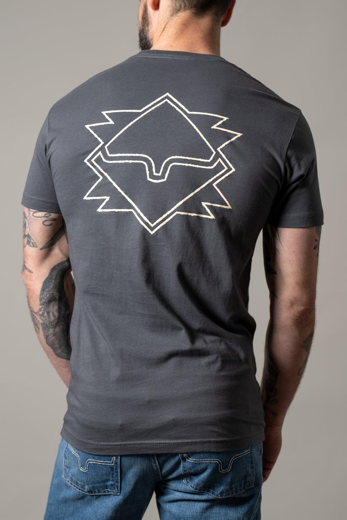 Kimes Ranch North Star, back view, Charcoal shirt with a large white geometric star graphic on the back
