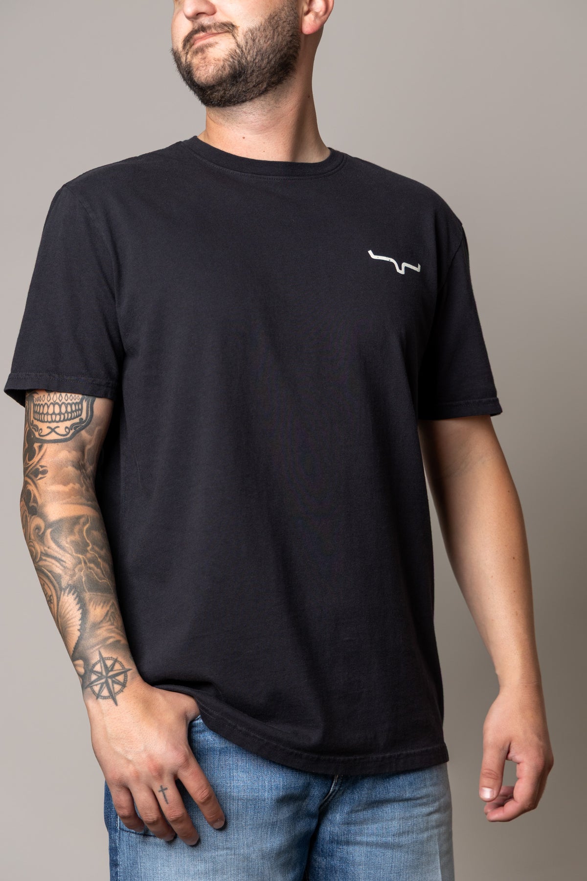Kimes Ranch Not Our First shirt in Black with a white Kimes Ranch logo on the chest