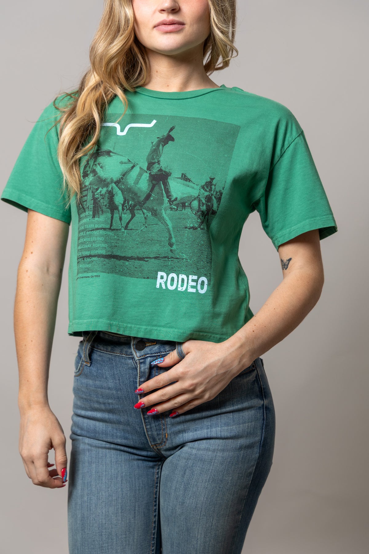 Kimes Ranch Not Our First shirt in Kelly Green with a rodeo graphic and RODEEO text