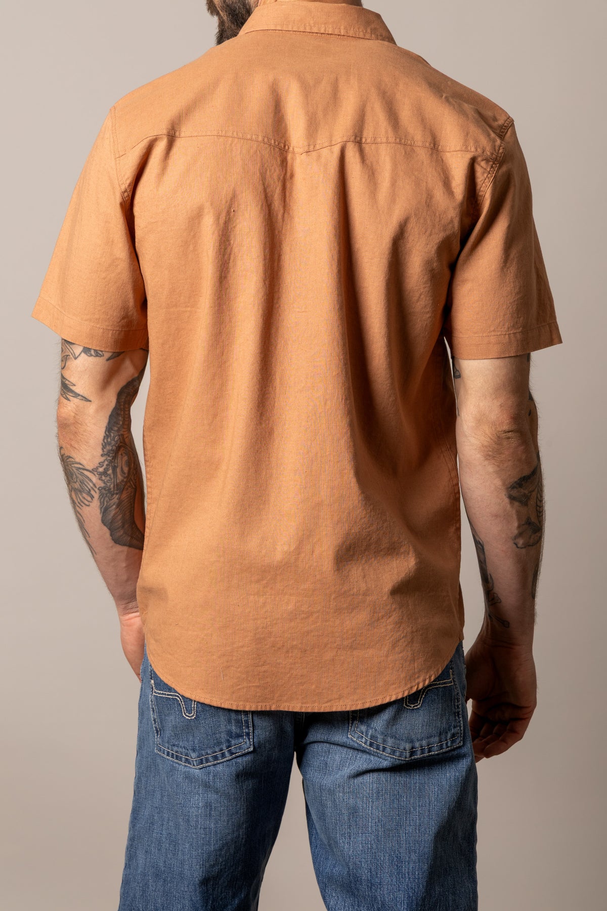 Kimes Ranch Nuce, back view, short sleeve dress shirt in orange with a back yoke and curved hem