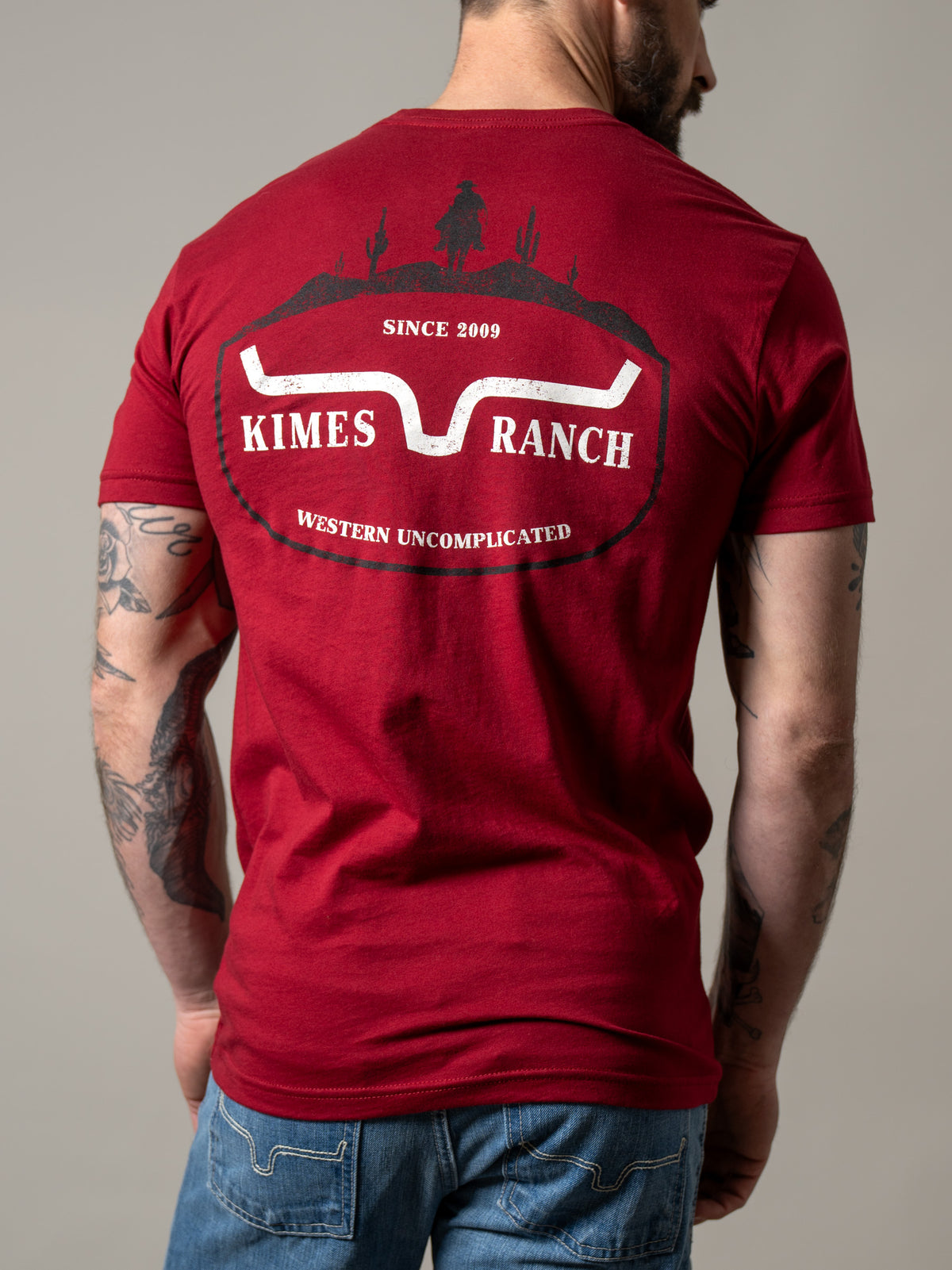 Kimes Ranch Old West shirt in Cardinal, back view, with a back graphic featuring a cowboy silhouette