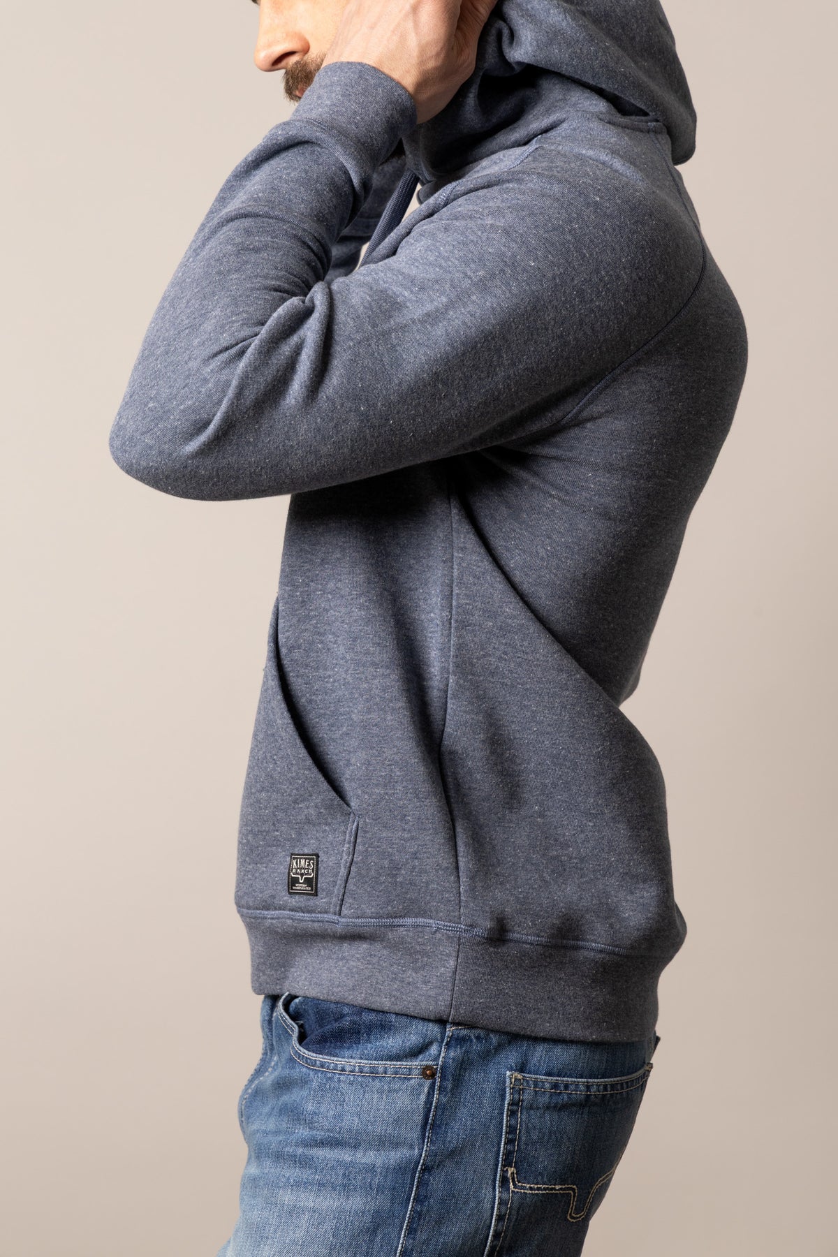 Kimes Ranch Outlier Hoodie in Blue Heather, side view, with long sleeves and a front pocket
