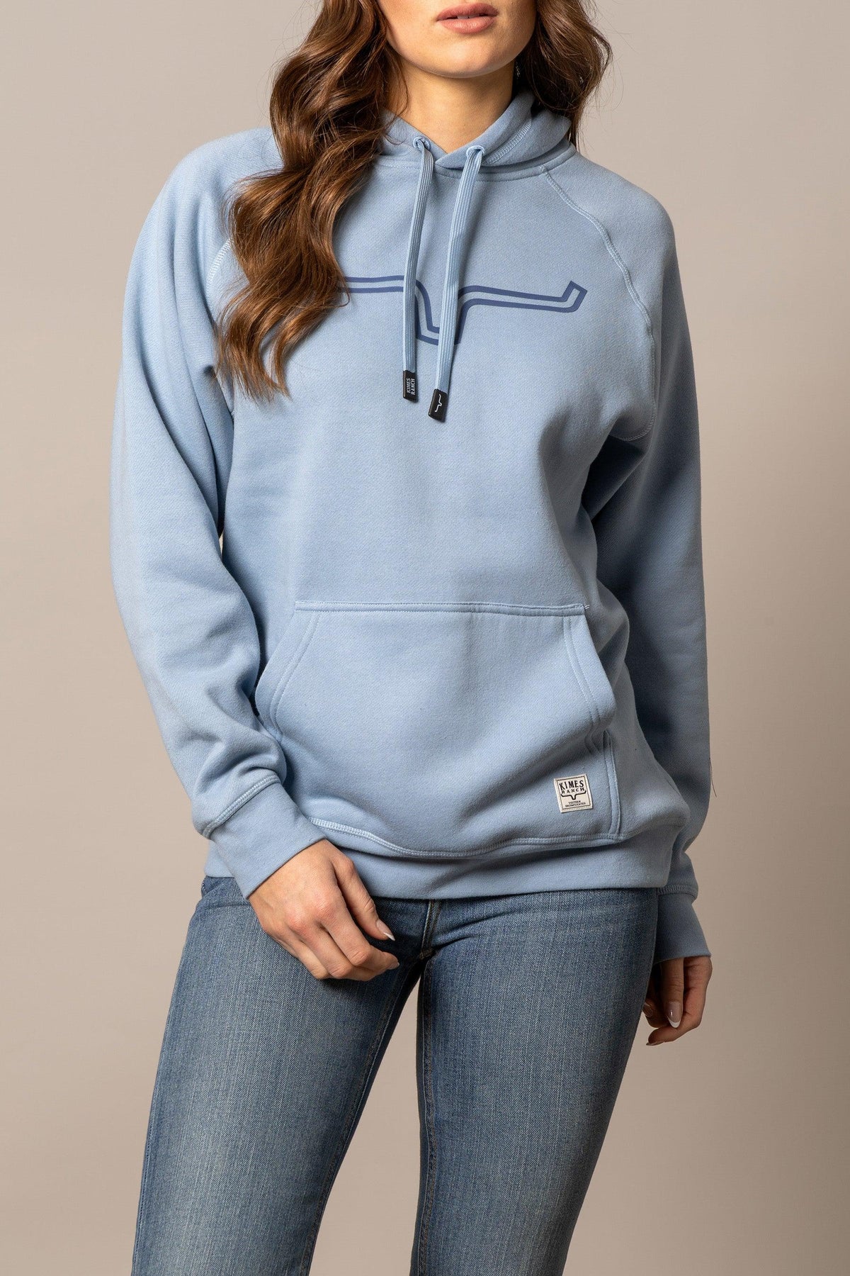 Kimes Ranch Ladies Outlier Hoodie in Carbon Blue with a front kangaroo pocket and a Kimes Ranch logo patch