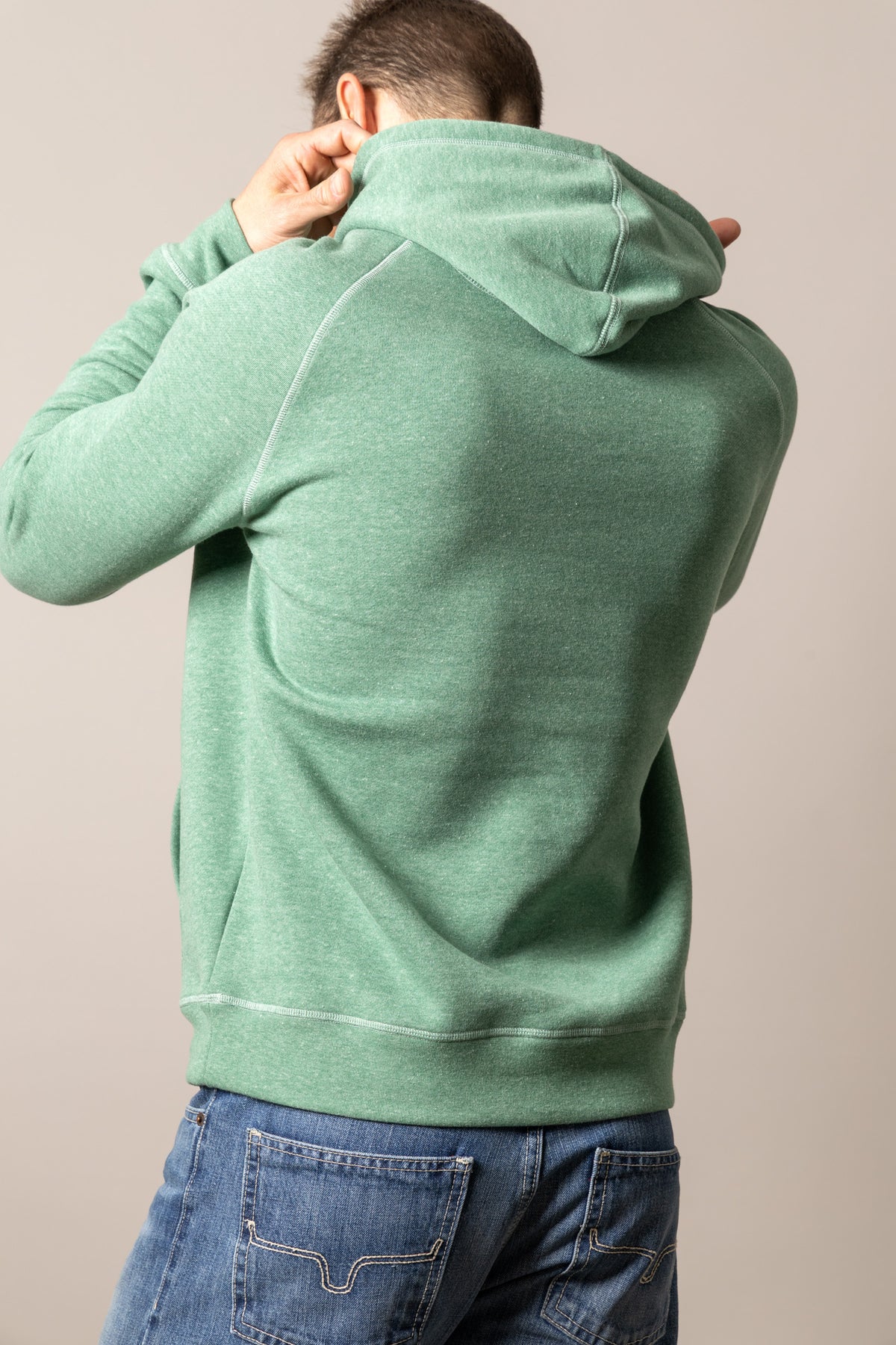 Kimes Ranch Outlier Hoodie in Green Heather, back view, with contrast stitching on the back yoke and hood