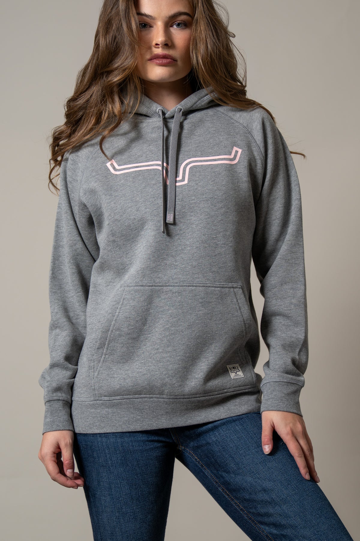 Kimes Ranch Ladies Outlier Hoodie in Grey Heather with a pink outline graphic and front kangaroo pocket