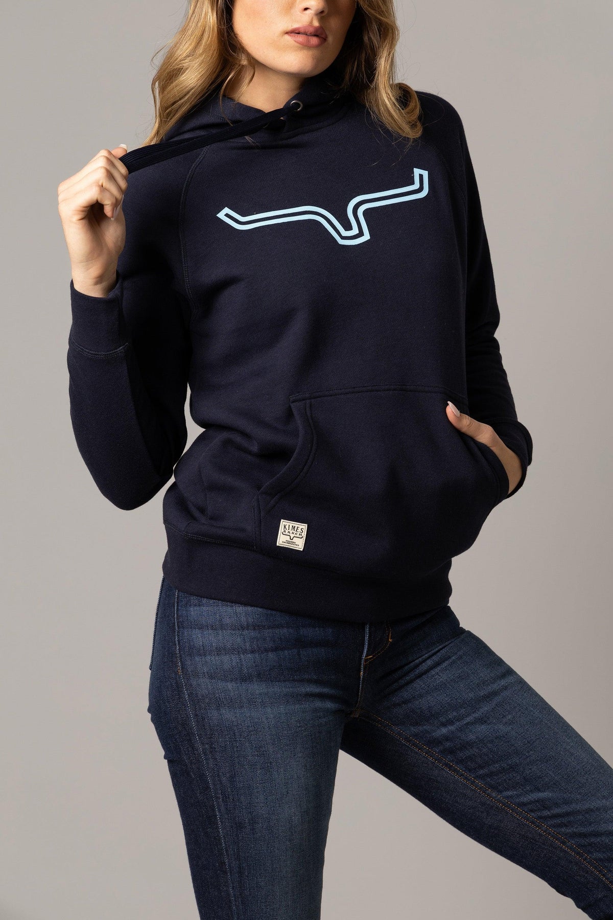 Kimes Ranch Ladies Outlier Hoodie in Navy with a light blue graphic print and front kangaroo pocket