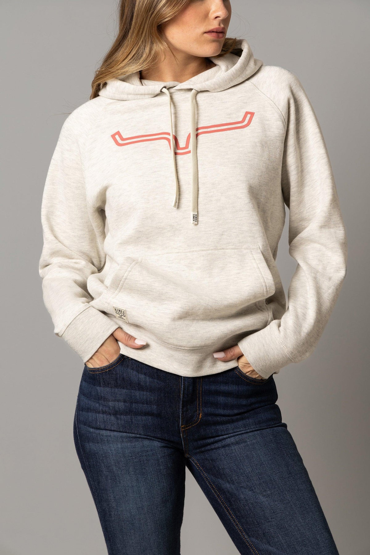 Kimes Ranch Ladies Outlier Hoodie in Oatmeal Heather with a coral longhorn logo and kangaroo pocket