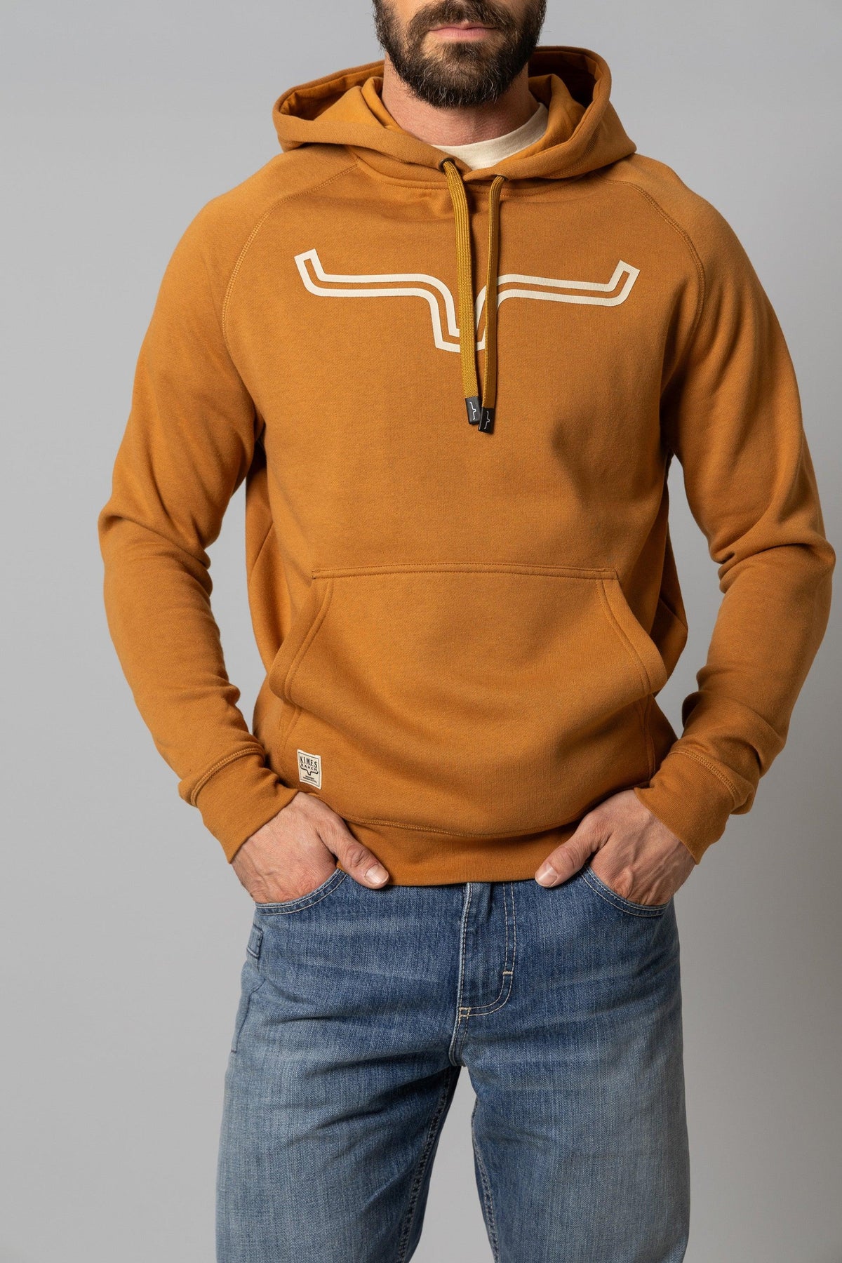 Kimes Ranch Outlier Hoodie in Work Wear Brown with a white logo on the chest and a front kangaroo pocket