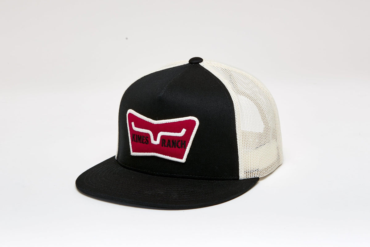 Kimes Ranch Panoramic Trucker Hat in Black, side view, with a red and white logo patch on the front