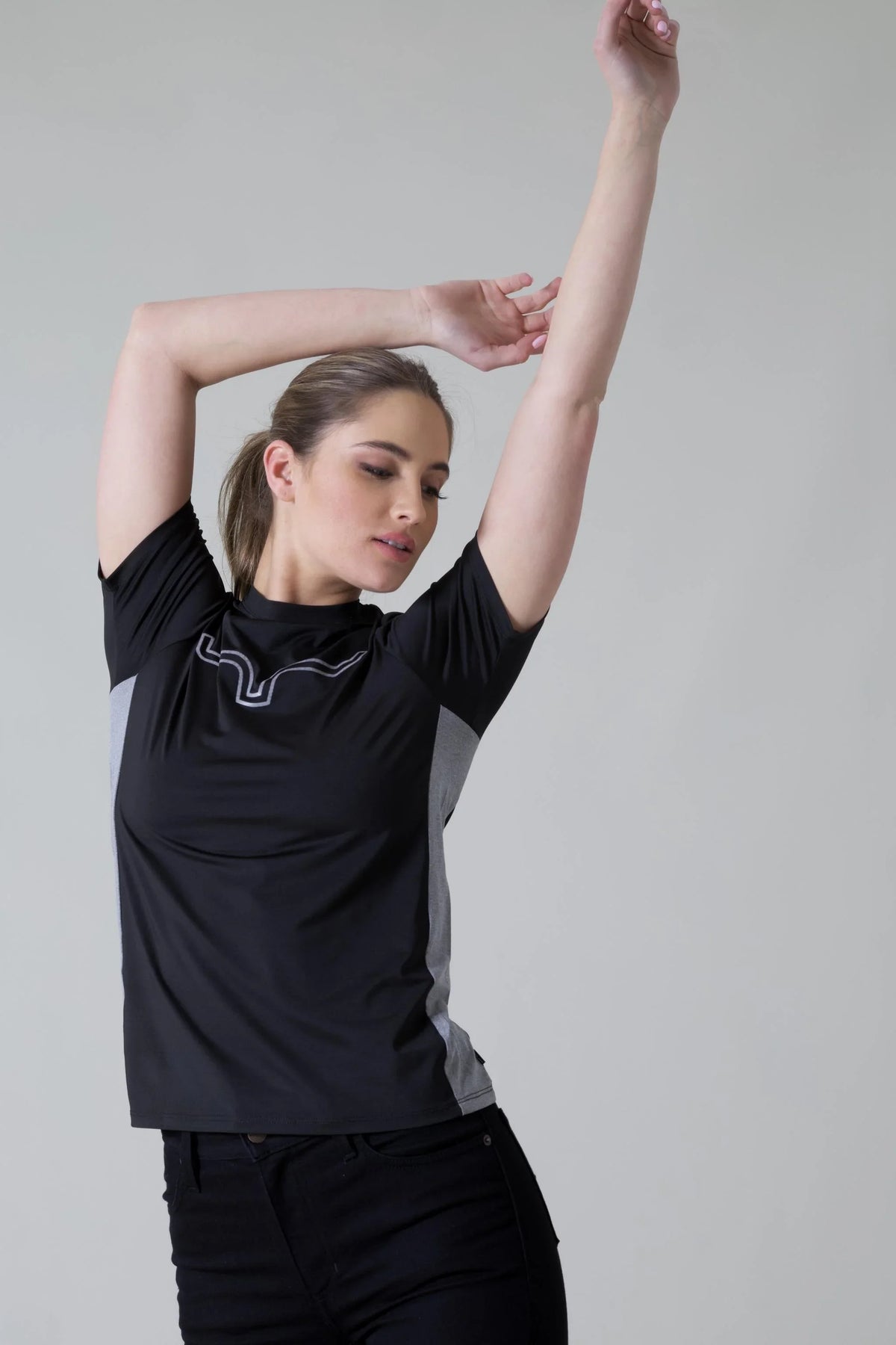 Kimes Ranch Ladies Phase 2 Tech Shirt in Black with grey side panels and a white logo on the chest