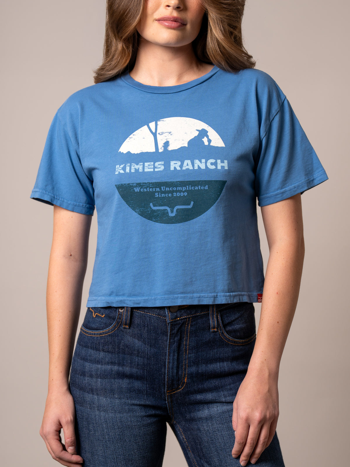 Kimes Ranch Rancher shirt in Carbon Blue with a graphic of a cowboy silhouette and Western Uncomplicated Since 2009 text