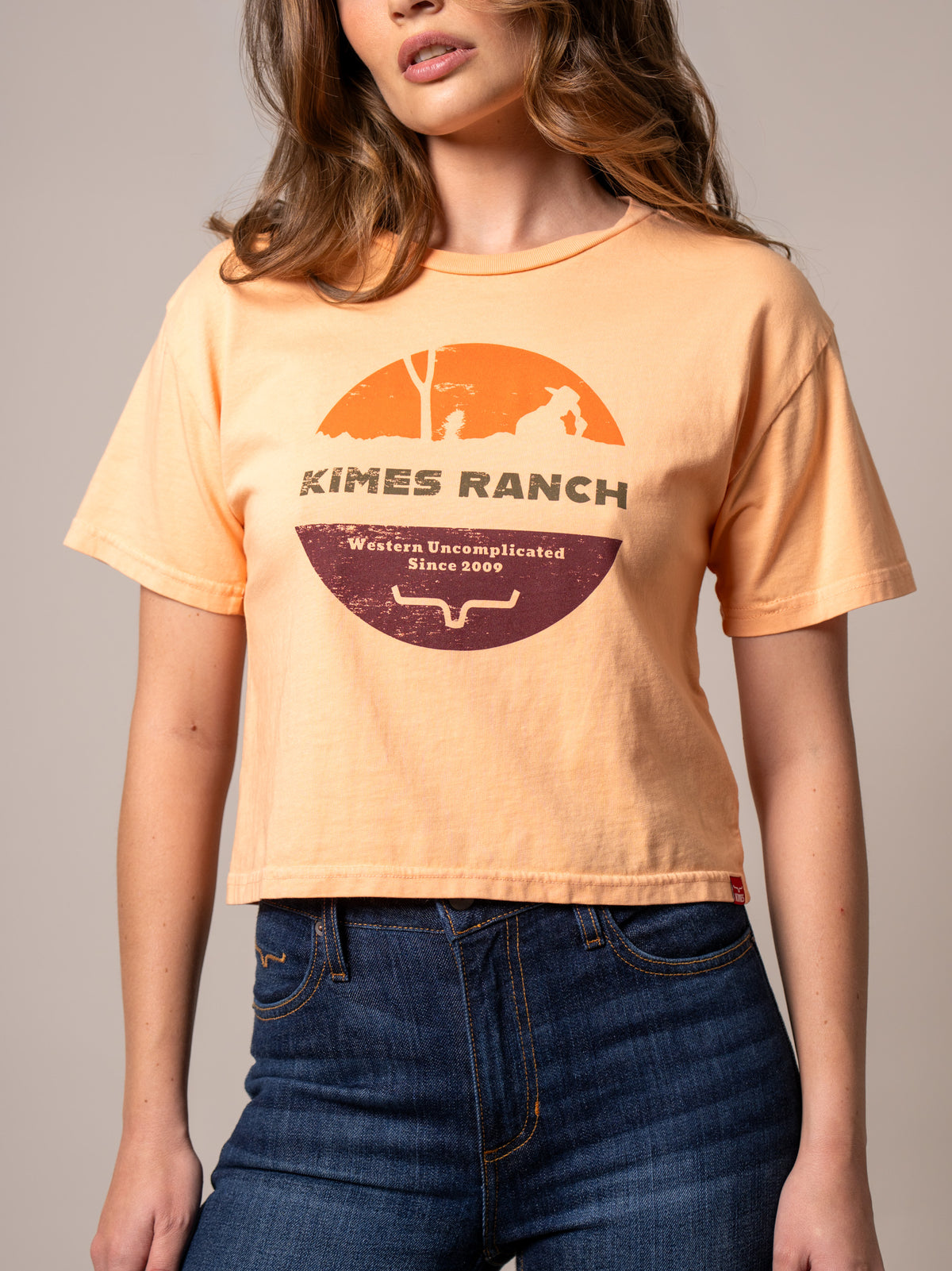 Kimes Ranch Rancher shirt in Peach with a vintage graphic and the text Western Uncomplicated Since 2009