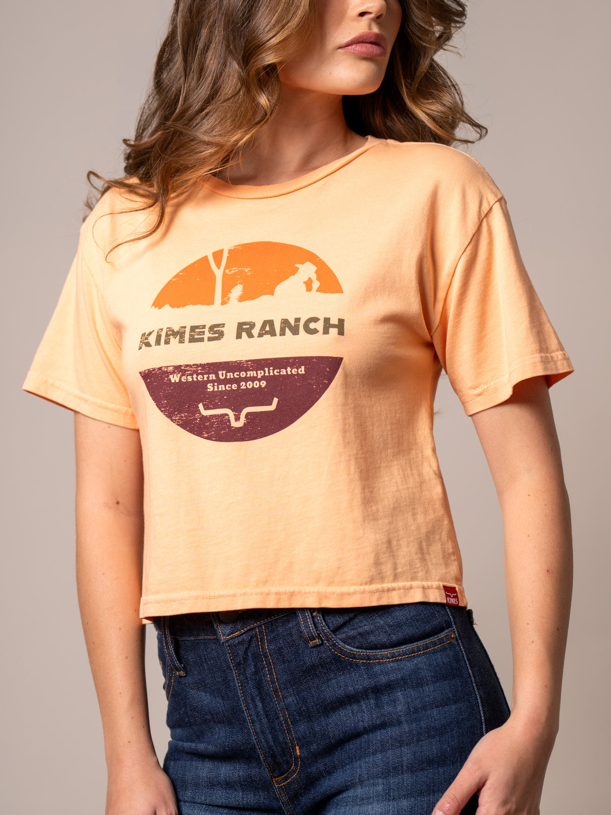 Kimes Ranch Rancher shirt in Peach with a vintage sunset graphic and Western Uncomplicated Since 2009 text