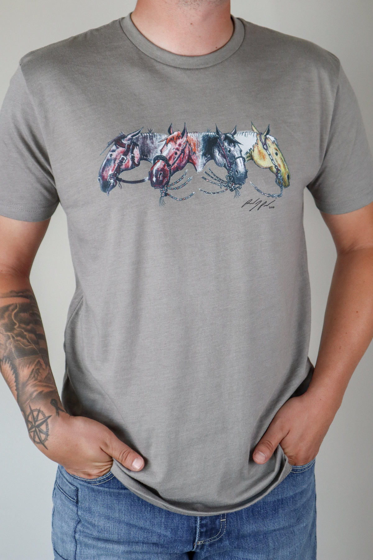 Kimes Ranch Randy Paul NRCHA Derby Tee Shirt in Grey with a graphic of four horses in a row