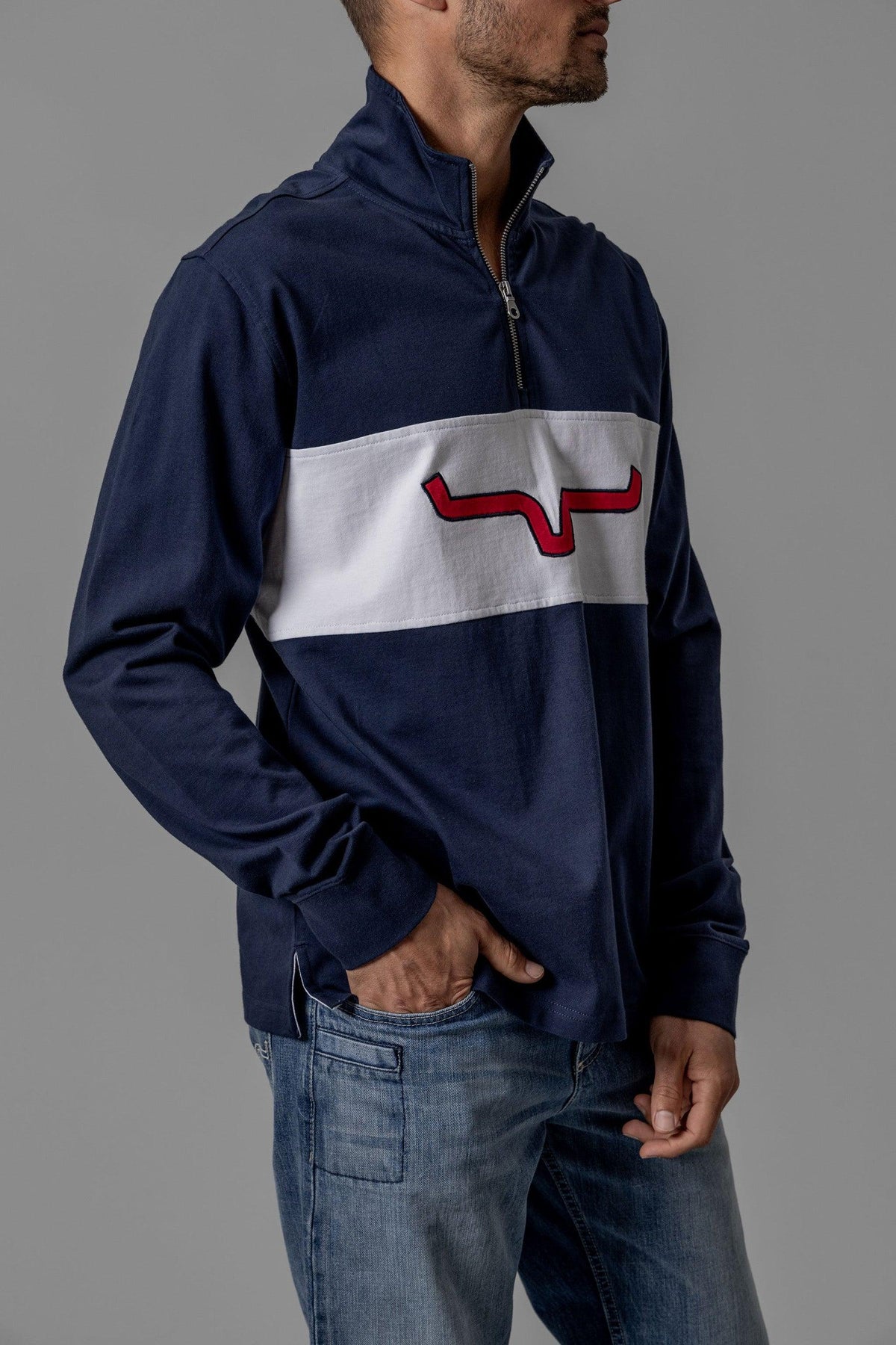 Kimes Ranch Razor Rugby sweatshirt in Navy, side view, with a white chest stripe and red logo