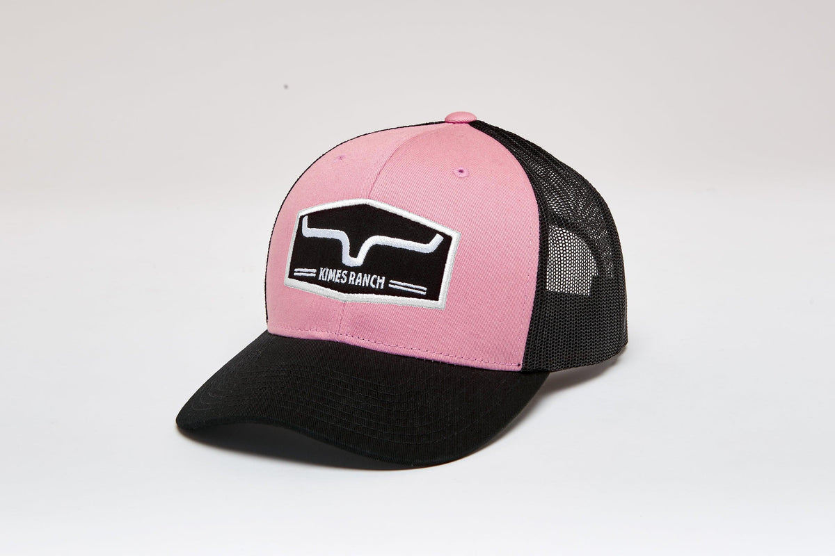 Kimes Ranch Replay Trucker Hat in Light Pink, side view, with black mesh back and front logo patch