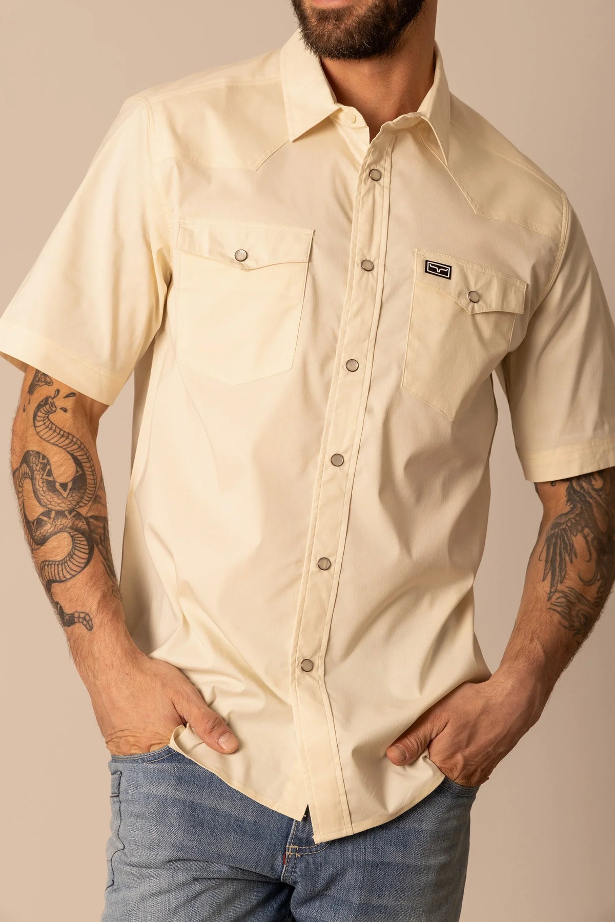Kimes Ranch Rio Short Sleeve Dress Shirt in Natural with two chest pockets and a Kimes Ranch logo patch