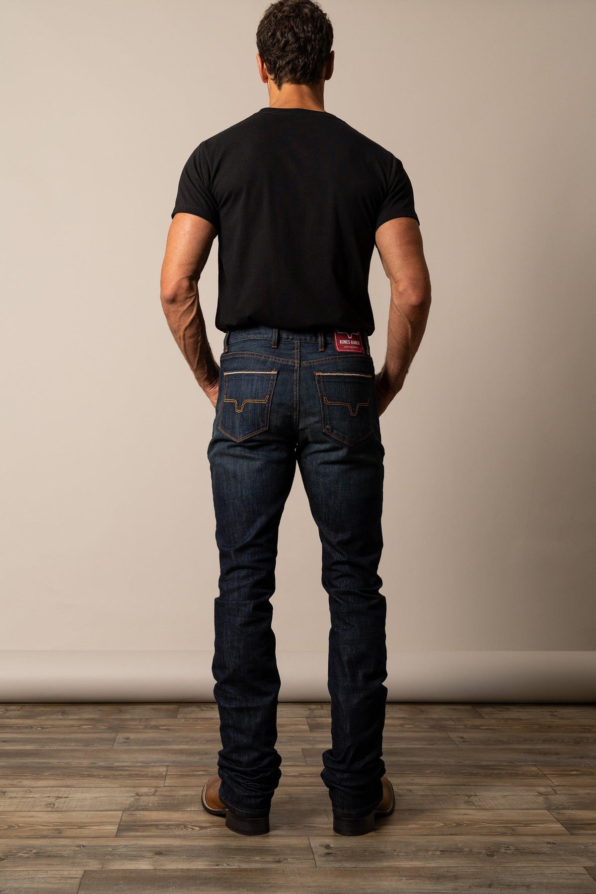 Kimes Ranch Roger Modern Bootcut jeans in Dark Wash, back view, with signature back pocket stitching and red logo patch