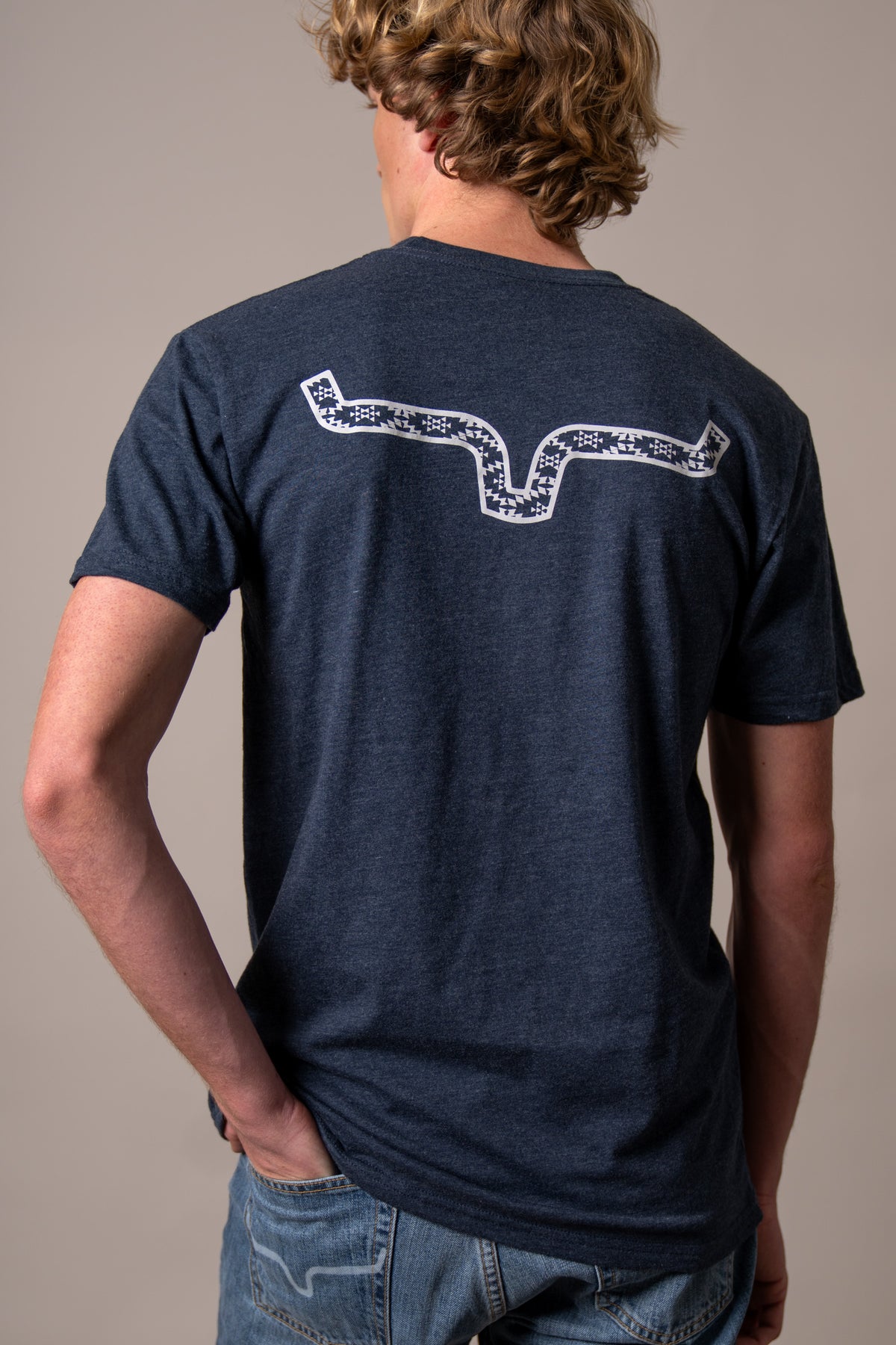 Kimes Ranch Rowell shirt in Midnight Navy, back view, with a white graphic of the Kimes Ranch logo on the back