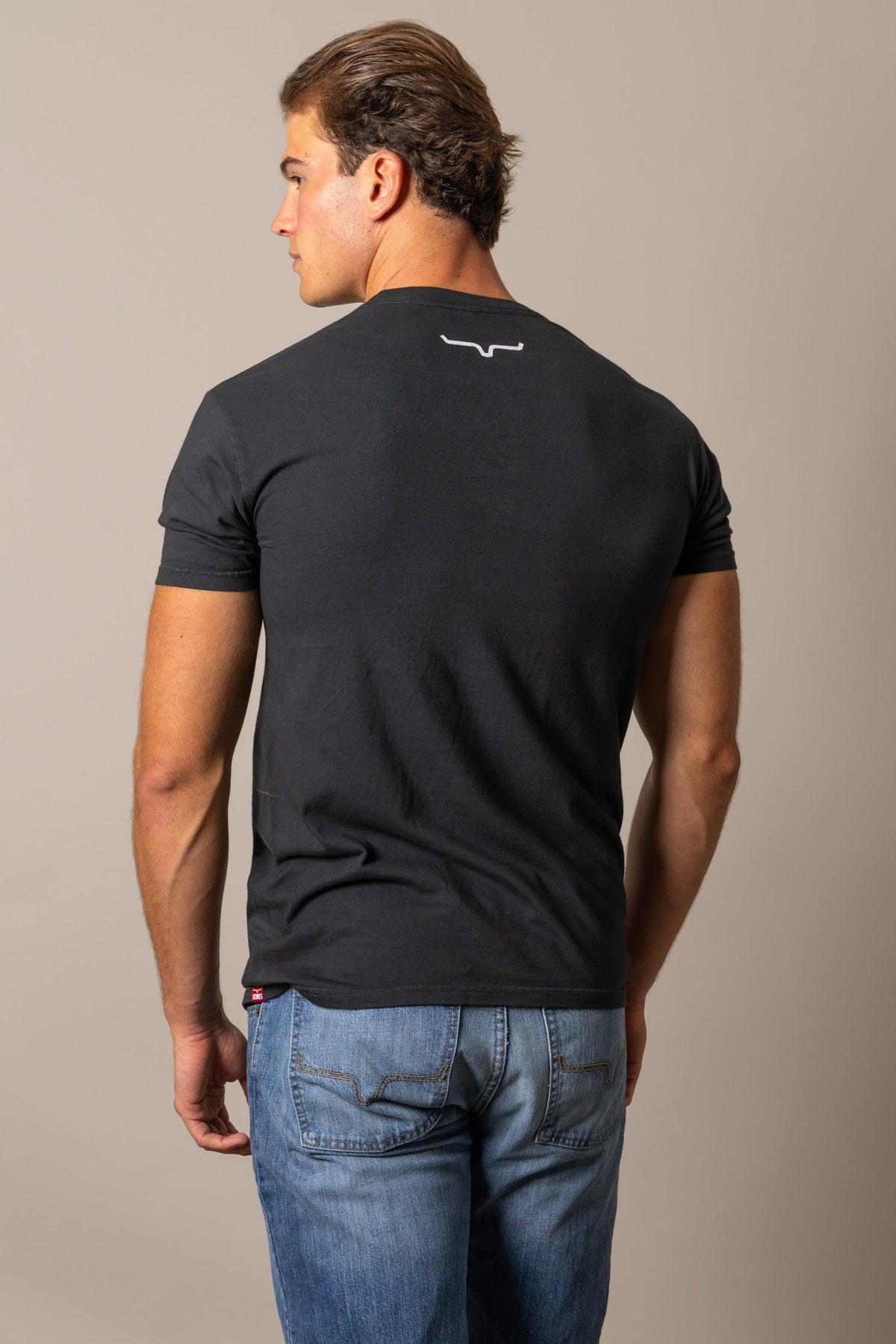 Kimes Ranch Runaway shirt in Black, back view, with a white logo at the back yoke