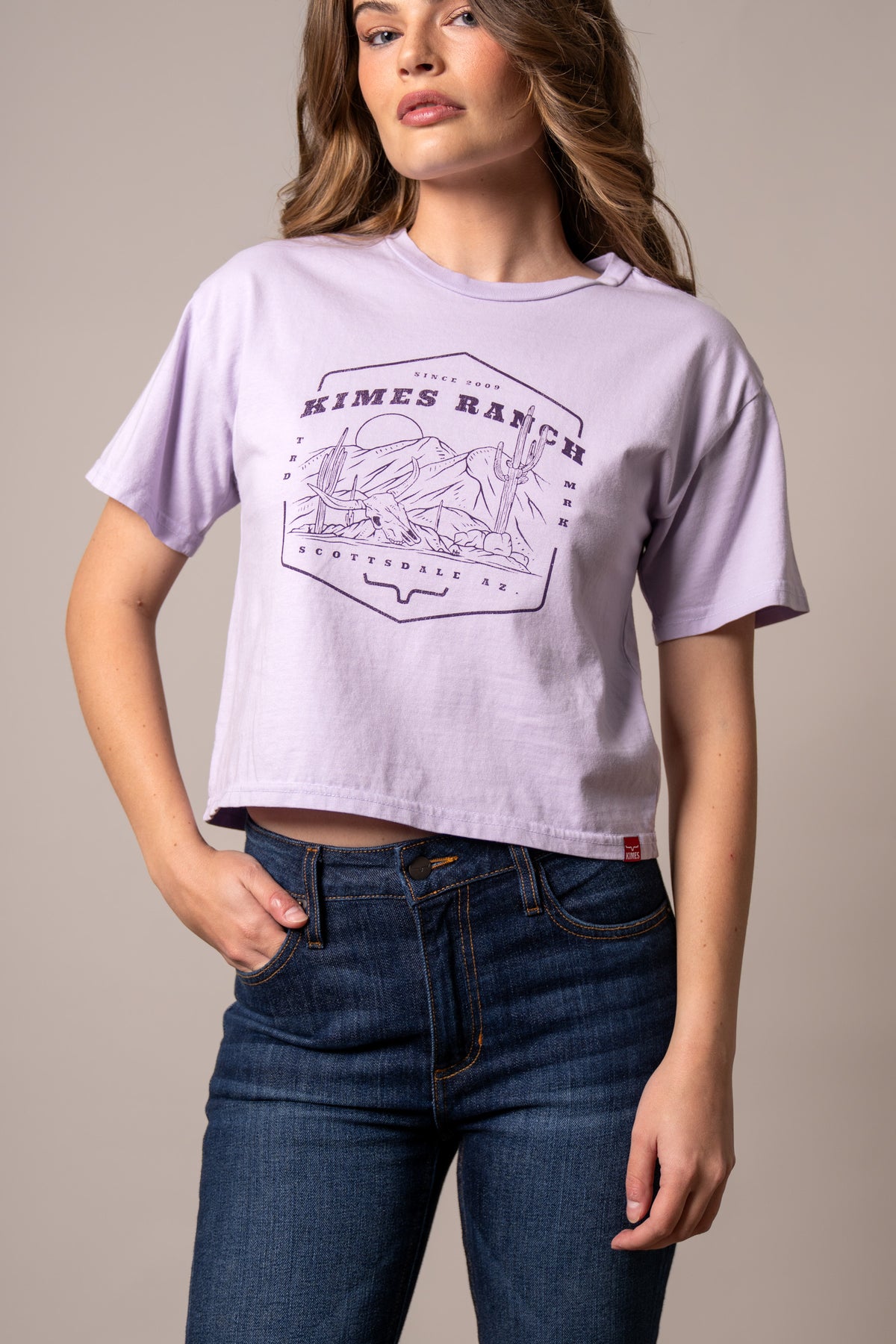 Kimes Ranch See For Miles Lavender short sleeve shirt with a desert landscape graphic and Scottsdale AZ text