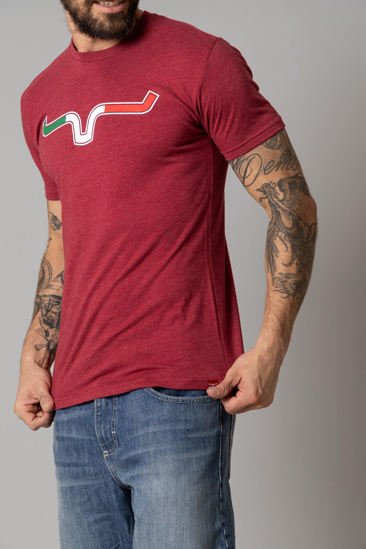 Kimes Ranch Semana Shirt in Cardinal with a stylized wavy graphic in green, white, and red on the chest