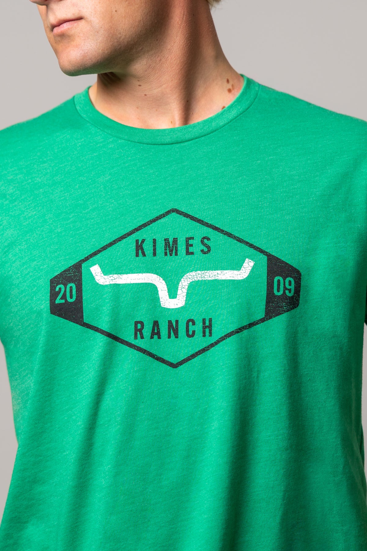 Kimes Ranch Serrano shirt in Kelly Green with a close-up of the front graphic featuring the Kimes Ranch logo