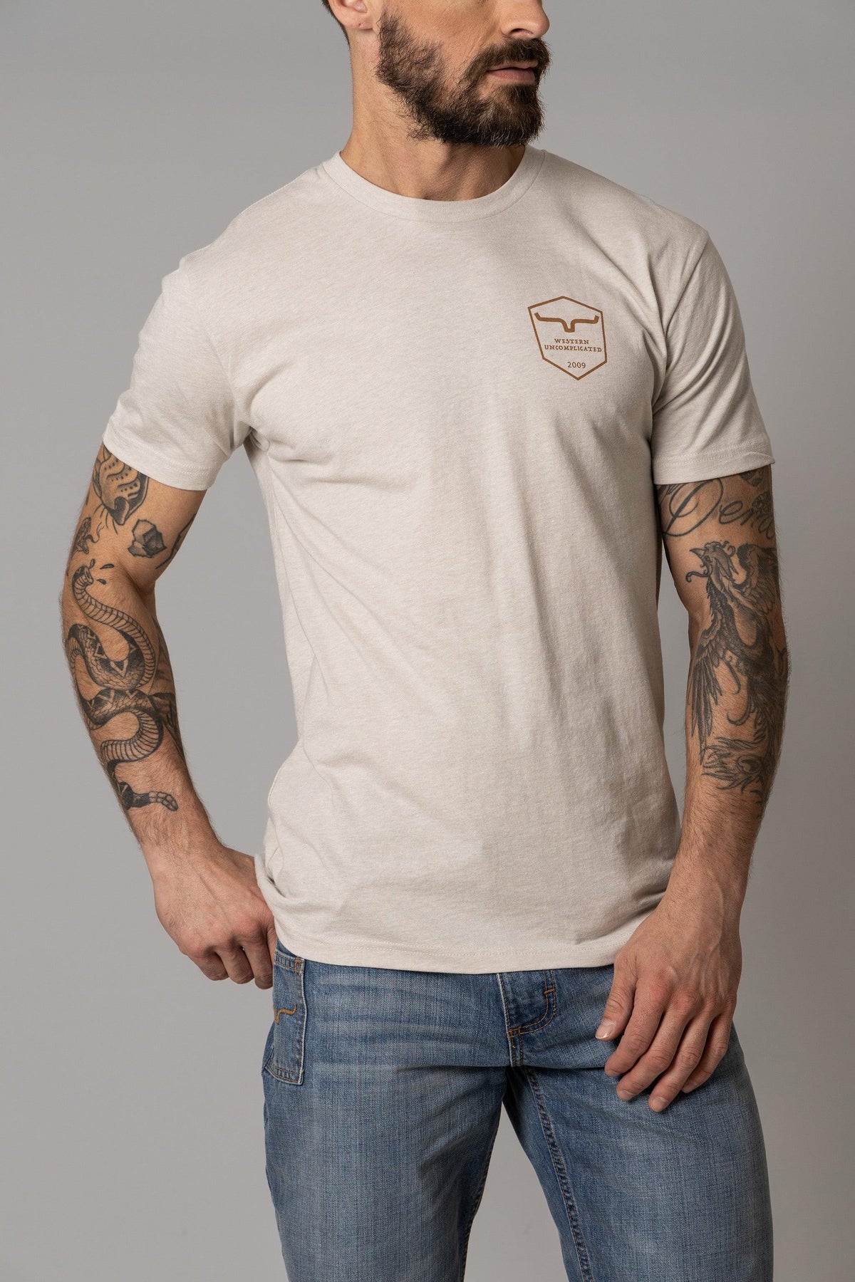 Kimes Ranch Shielded Trucker Shirt in Sand with a chest pocket logo reading Western Uncomplicated 2009