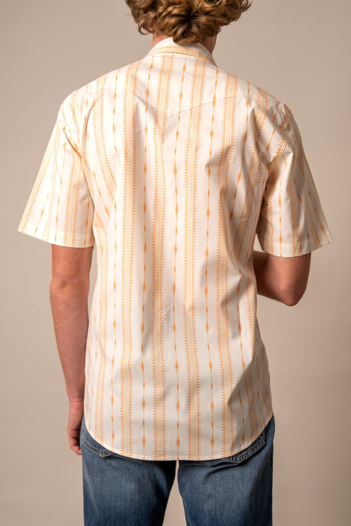 Kimes Ranch Sonny dress shirt in Orange, back view, with a vertical patterned design and short sleeves